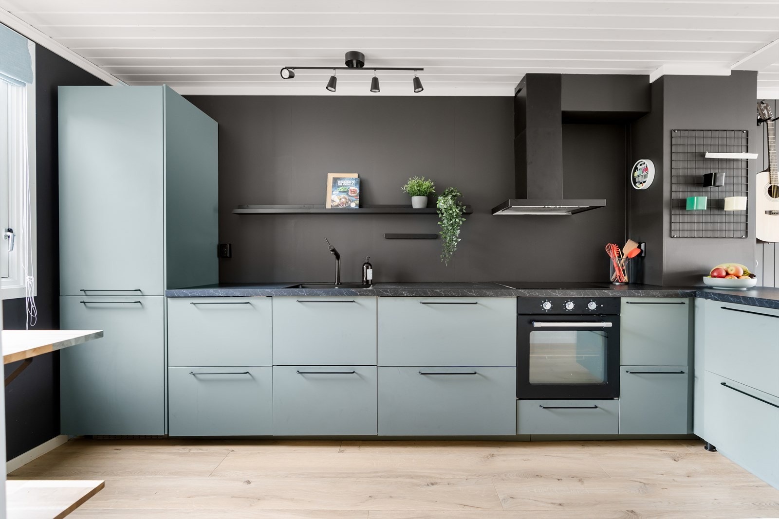 Innredningen har glatte, fabrikklakkerte fronter, samt benkeplate i laminat med planlimt kum i kompositt/plast. Det er malte flater over benkeplaten, samt montert vegghylle. Galleribilde