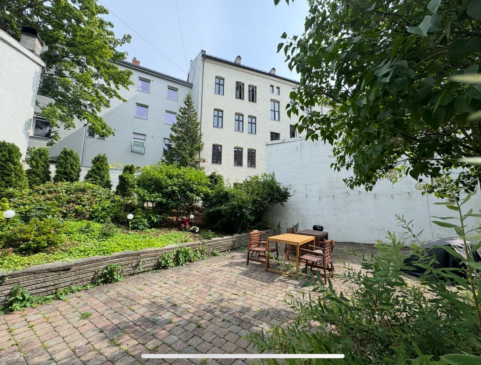 Idyllisk bakgård med sittegrupper om sommeren Galleribilde