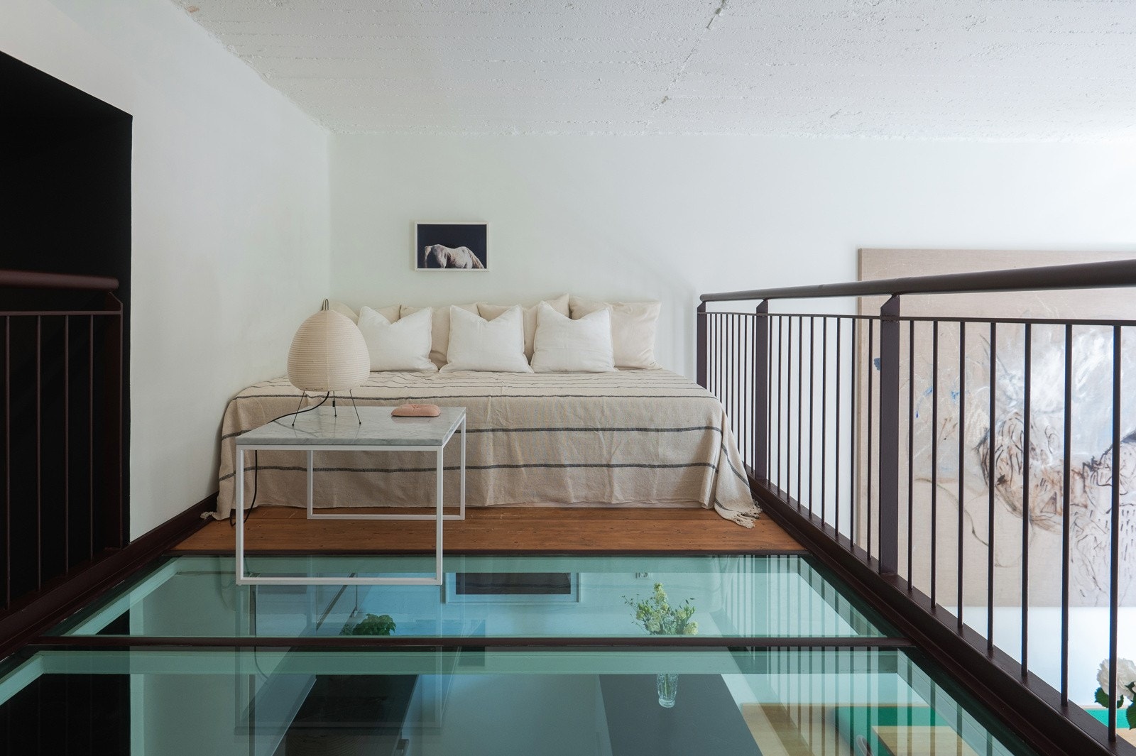 Gulvet har brede, mørke trebord, og innfelt glassfelt i gulvet Galleribilde