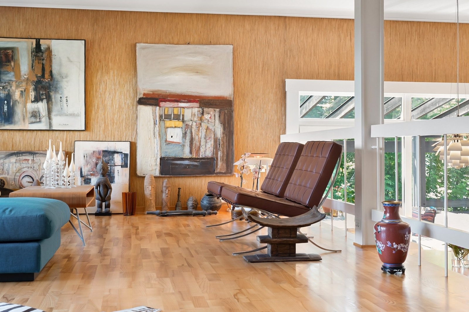 Lyst rom med parkettgulv, store vinduer og kunst på veggene. Galleribilde