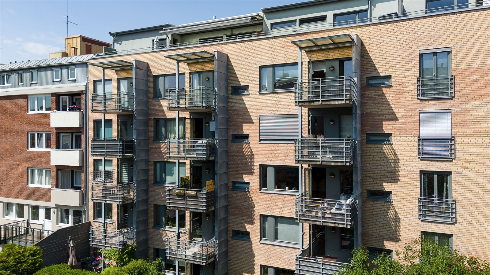 Velholdt teglsteinsbygg fra 2001 med flere private balkonger og moderne fasade. Galleribilde