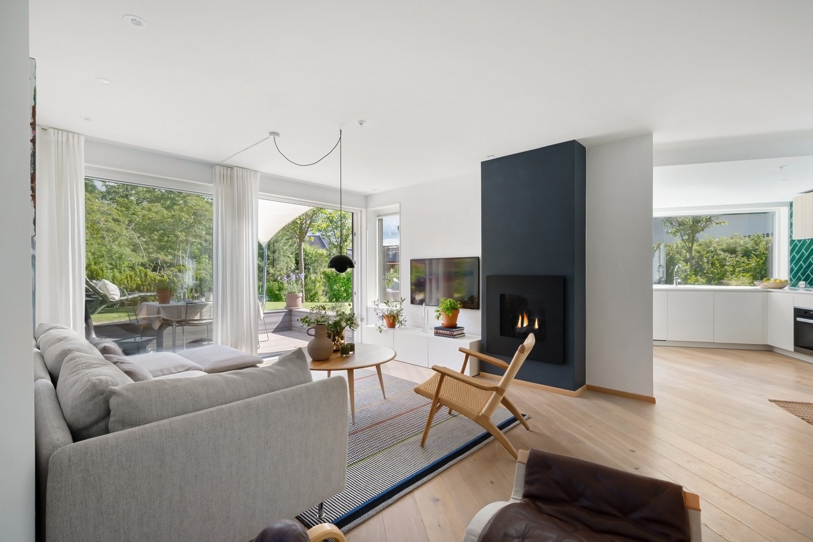 Stuen og spisekjøkkenet ligger i hver sin naturlige fløy - Store vindusflater som rammer inn den frodige utsikten. Galleribilde