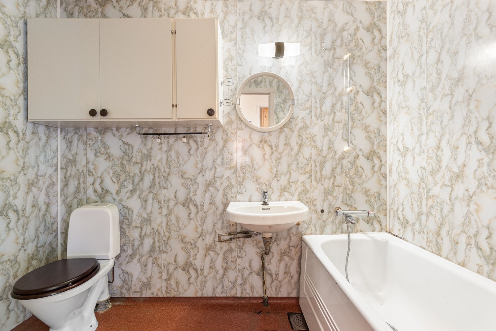 Romslig baderom modent for totalrehabilitering. Galleribilde