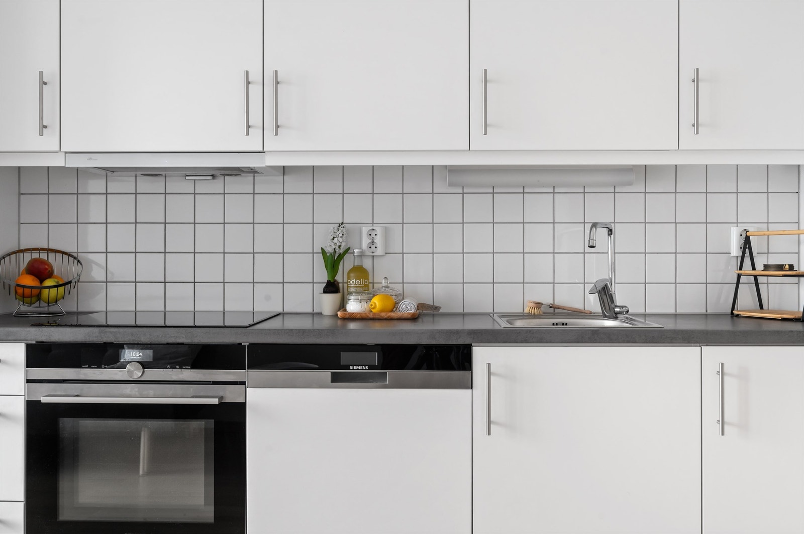 Hvitevarene er sømløst integrert i innredningen og består av oppvaskmaskin, induksjonstopp, stekeovn og kjøle-/fryseskap fra Siemens. Galleribilde