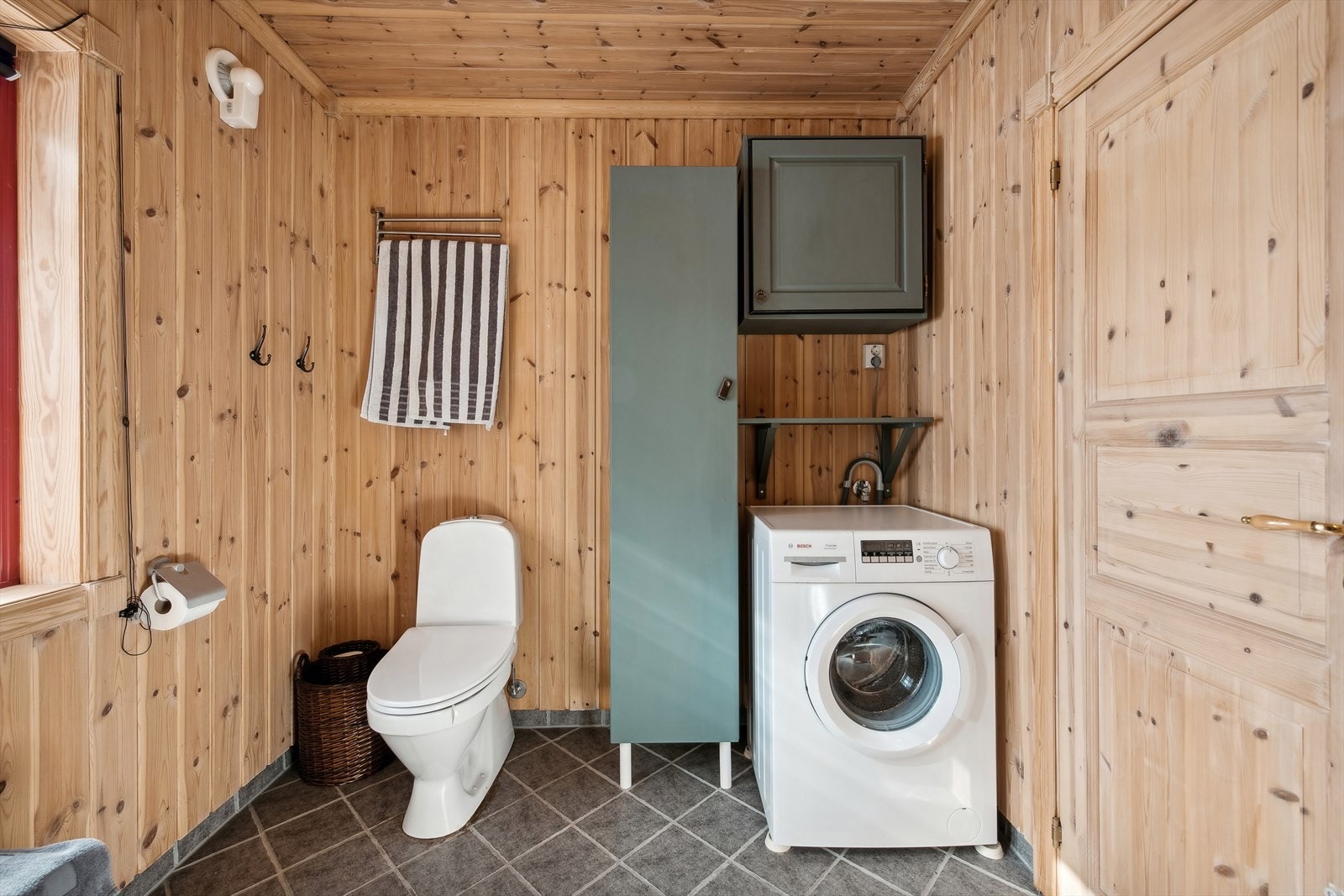 Det romslige badet er utstyrt med tilkoblingsmuligheter for vaskemaskin, noe som gir praktisk og effektiv håndtering av klesvasken. Galleribilde