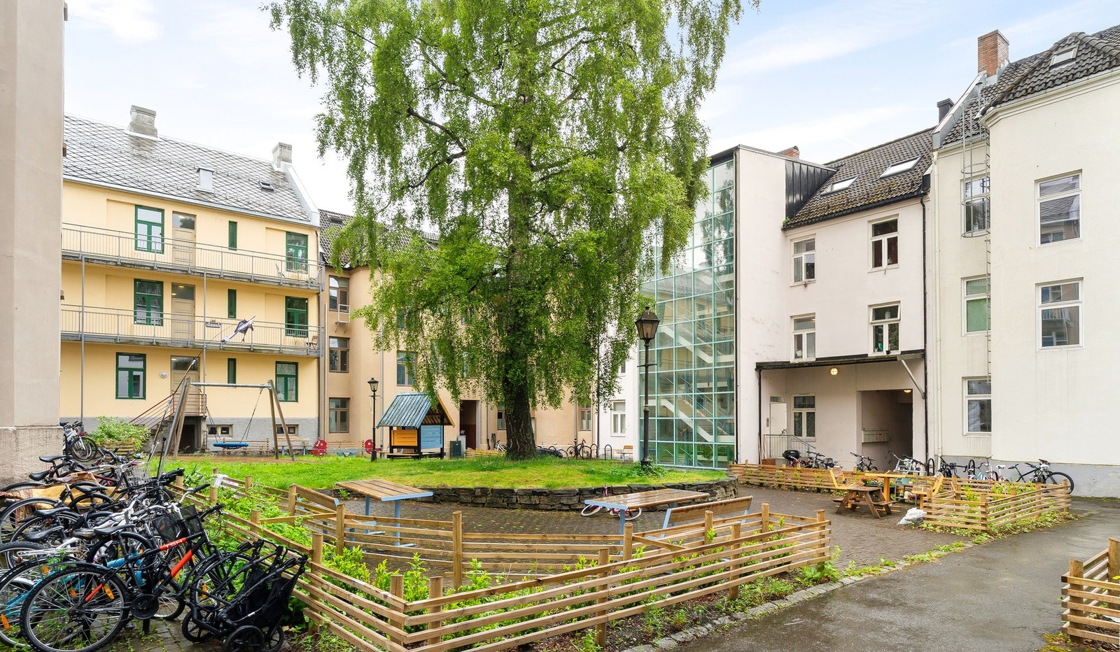 Fellesbakgård med sykkelparkering og lekeplass. Galleribilde
