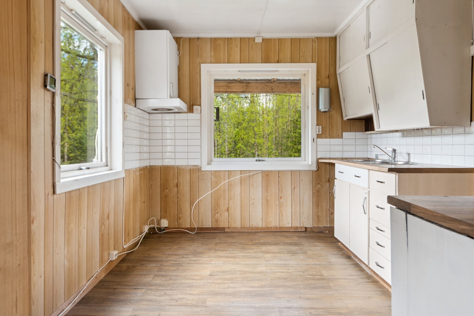 Kjøkkenet har malte fronter og laminat benkeplate Galleribilde