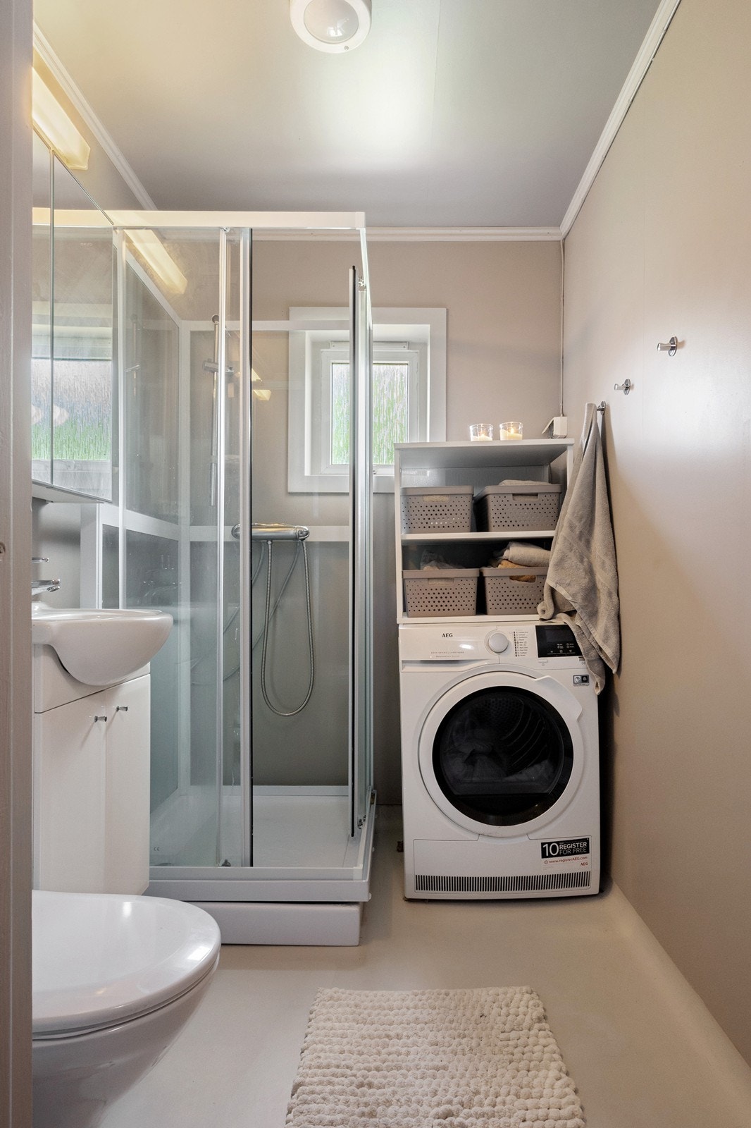 Badet har blitt modernisert med malte plater og belegg . Innredningen består av nedfelt servant, toalett, dusjkabinett fra 2024 og det er opplegg for vaskemaskin. Galleribilde