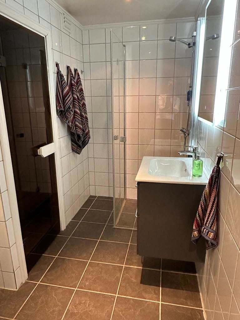Badet har flislagte overflater og gulv med varme. Galleribilde