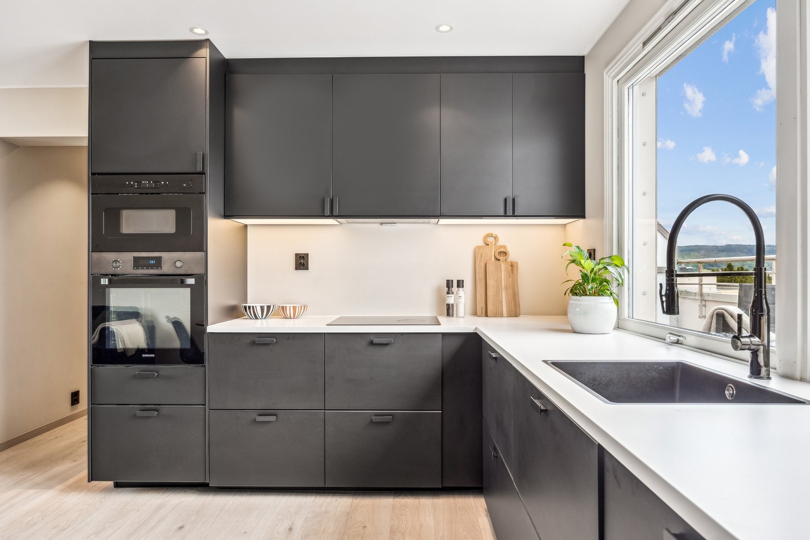 Kjøkkenet er utstyrt med integrerte hvitevarer som oppvaskmaskin, stekeovn, induksjonstopp, mikrobølgeovn, kombiskap og avtrekk over stekesonen - i tillegg er det montert fuktsensor med automatisk vannstopper. Galleribilde