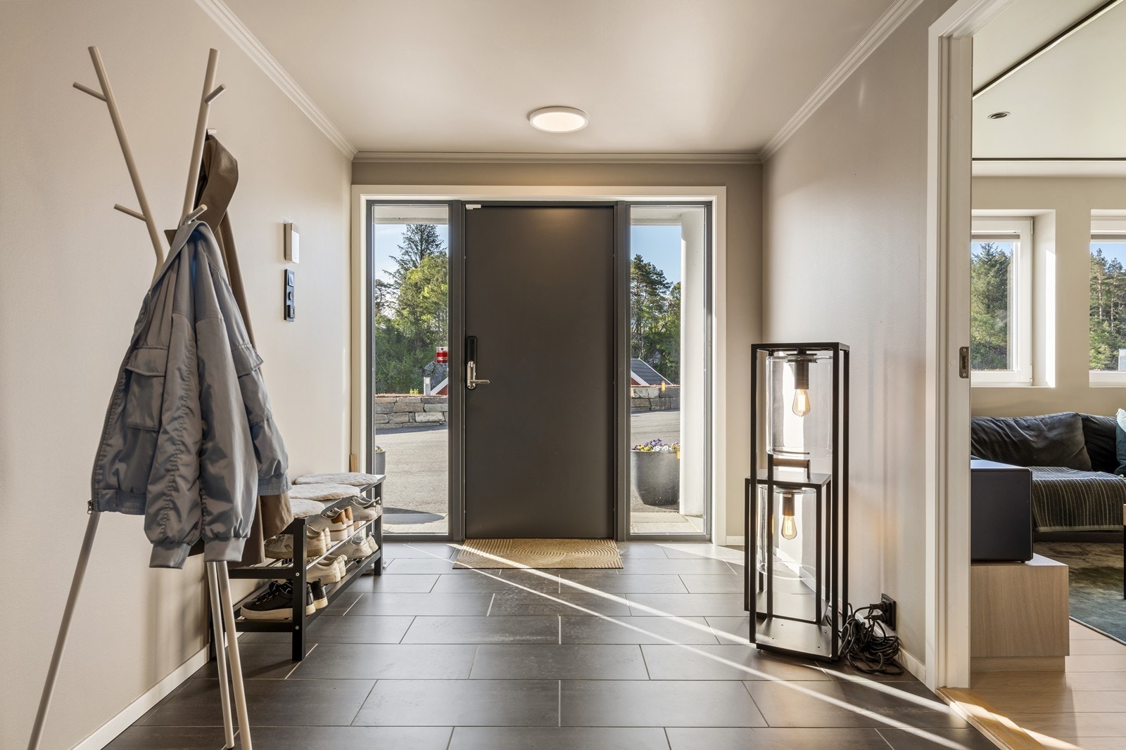 Velkommen inn til en romslig entré med flislagt gulv Galleribilde