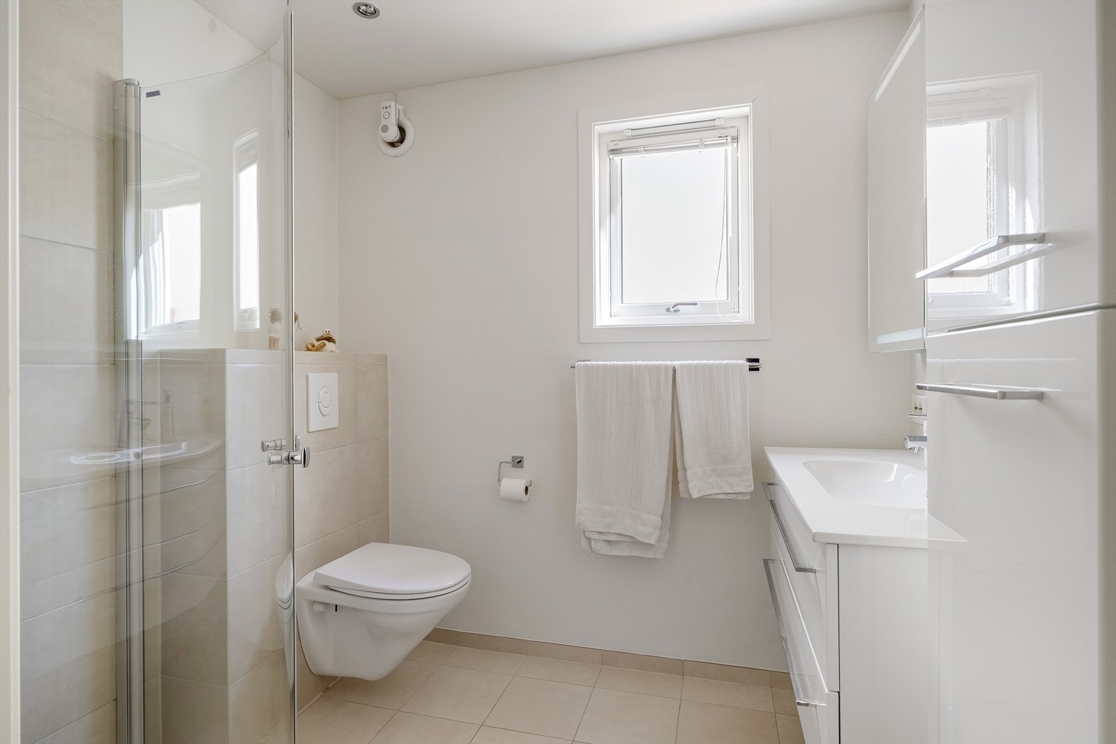 Baderom i kjeller med fliser på gulv og spotter i tak Galleribilde