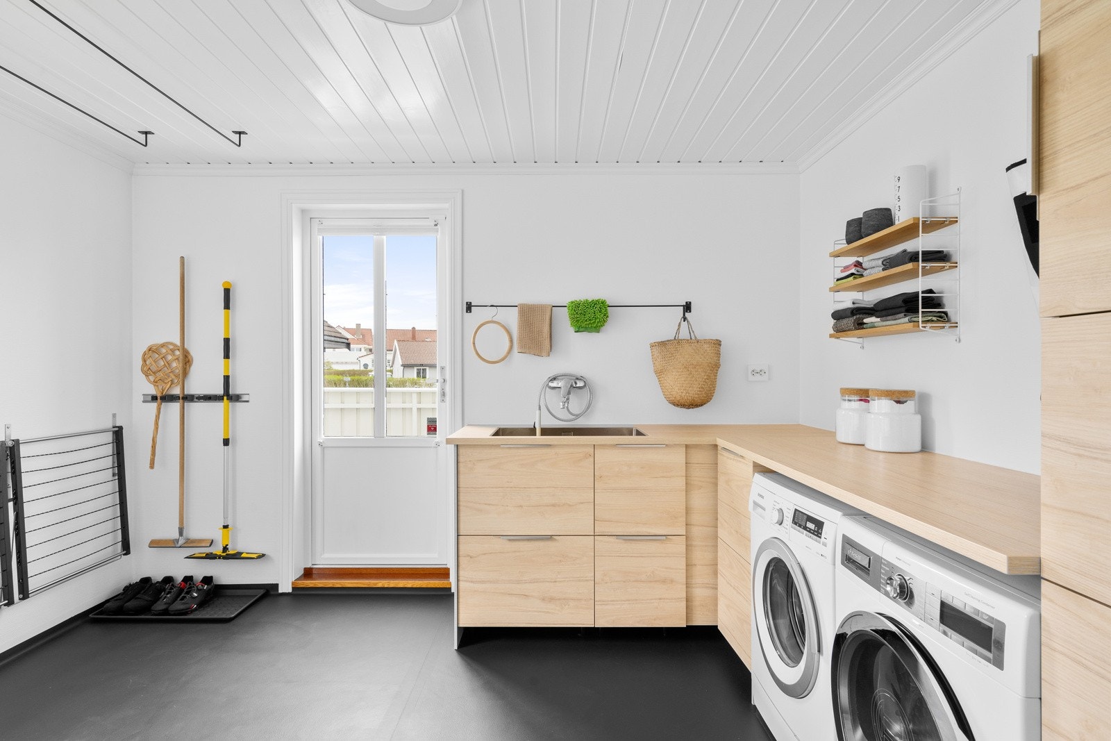 Praktisk og oppgradert vaskerom med funksjonell innredning fra 2018 - et ryddig og effektivt arbeidsrom med god lagringsplass og gjennomtenkte løsninger Galleribilde