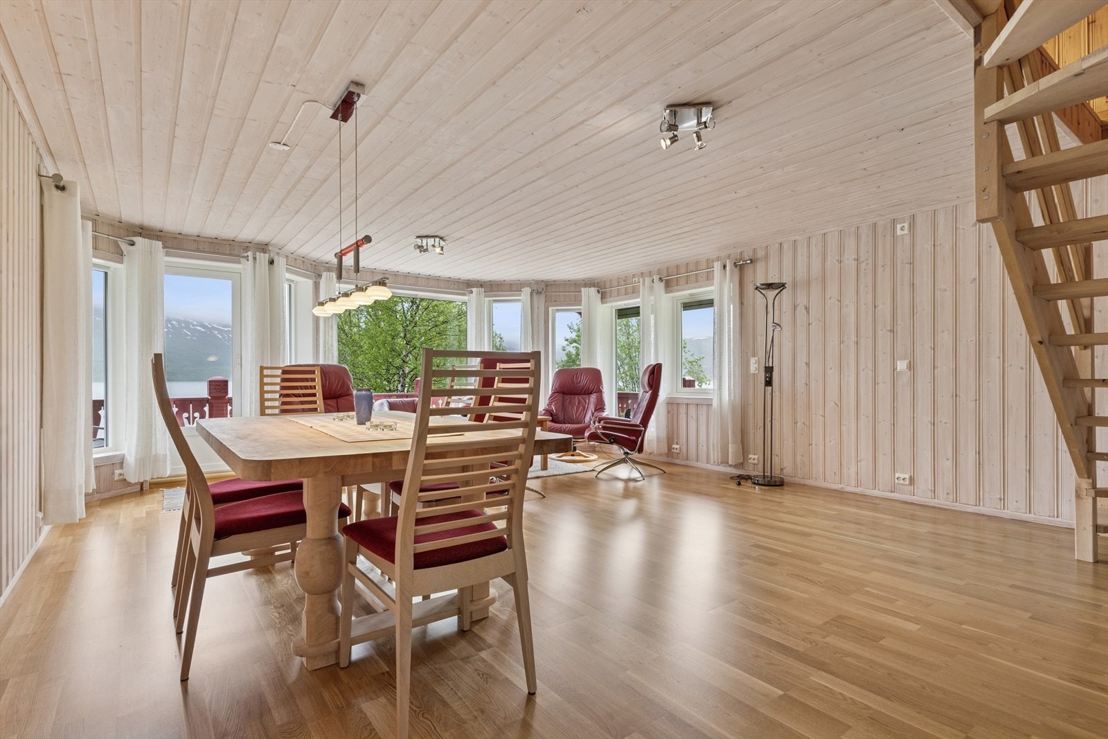 Stuen og spisestuen fremstår som lyse, innbydende og luftige med store vindusflater som slipper inn rikelig med dagslys og gir en fantastisk utsikt mot Øvre Fiplingvatn og omkringliggende fjell. Her kan du virkelig nyte naturen - selv fra sofakroken. Galleribilde