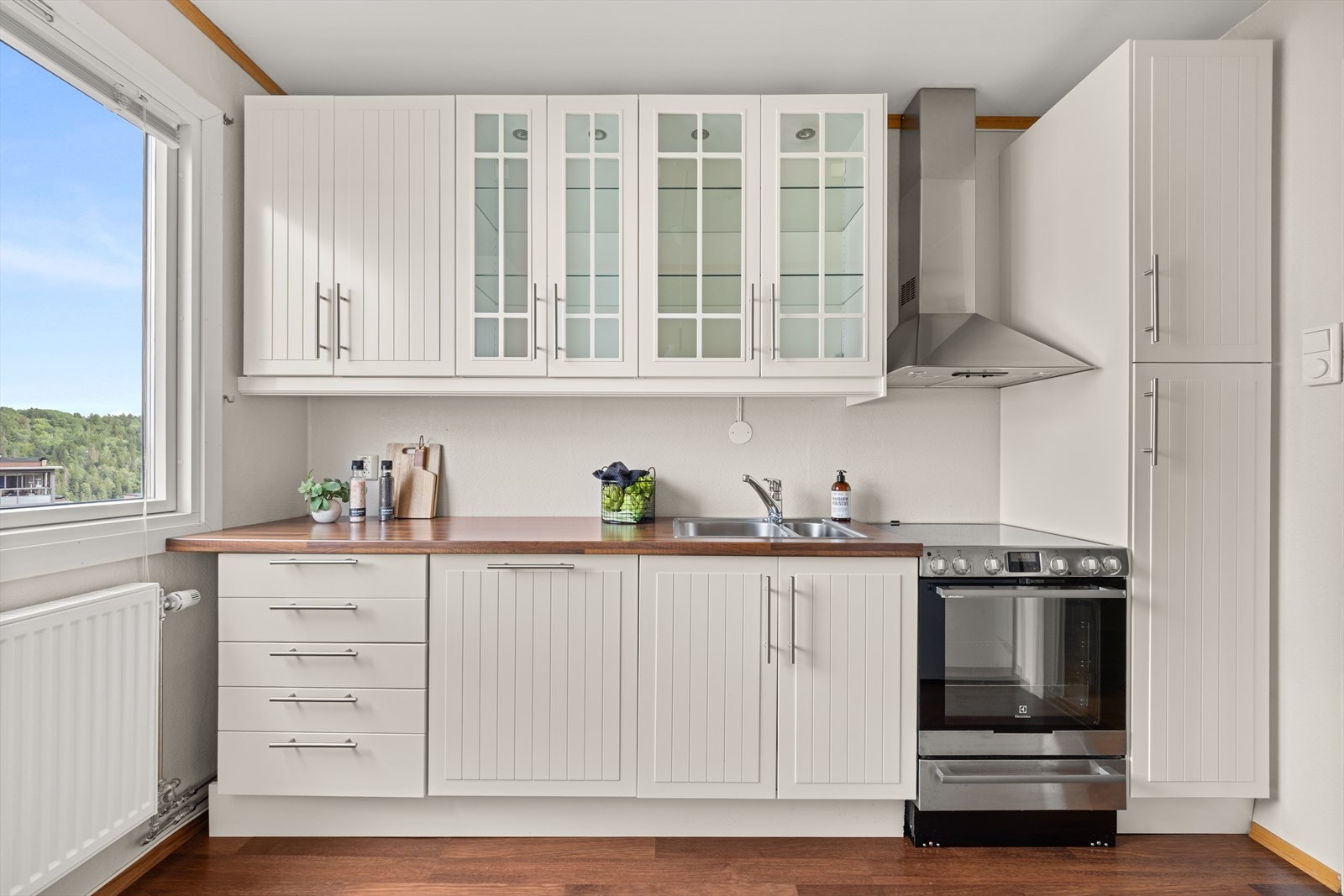 Kjøkkenet har profilerte fronter og benkeplate i laminat Galleribilde