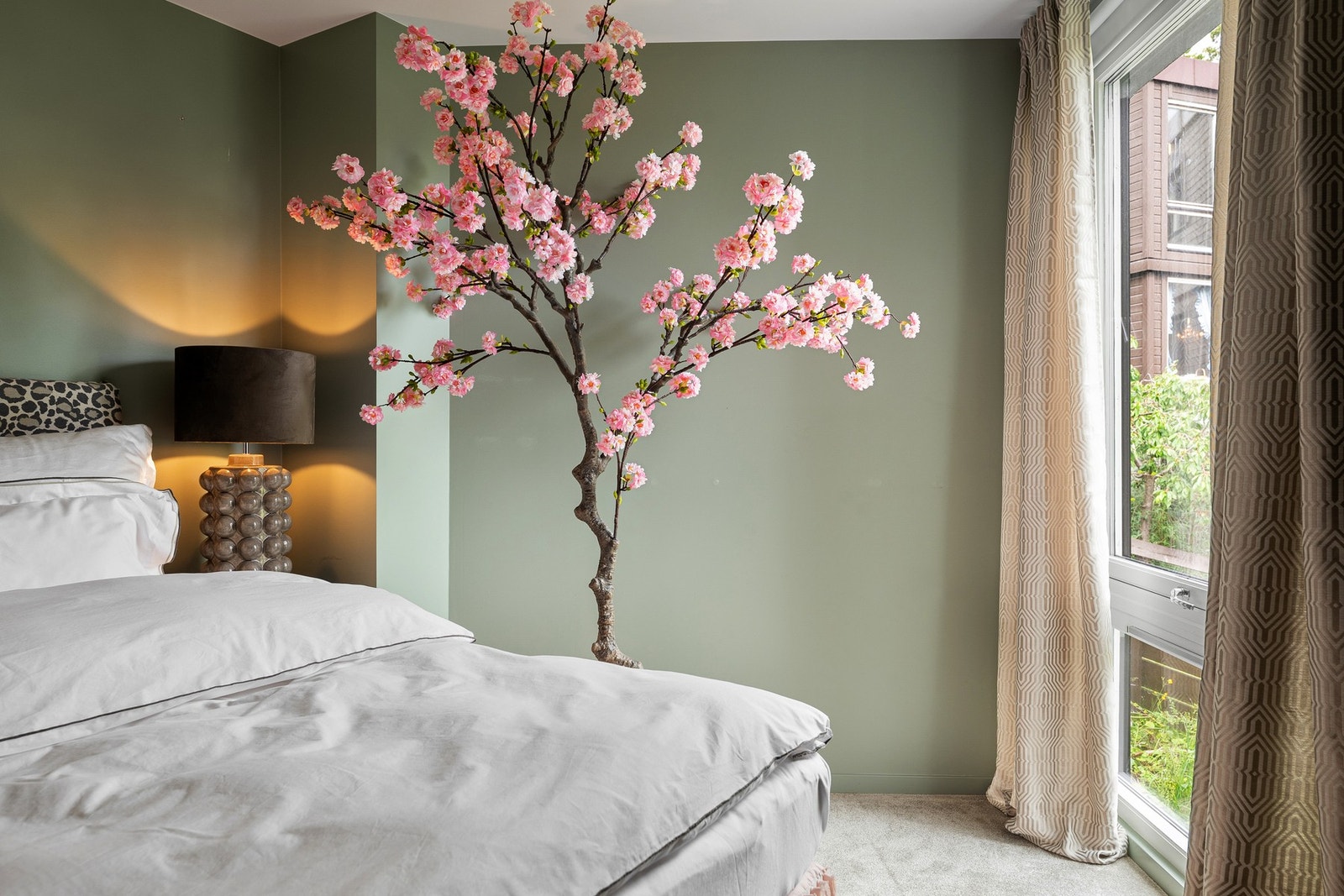 Soverommet har en stille og tilbaketrukket plassering med utsyn mot grønne trær og natur. Galleribilde