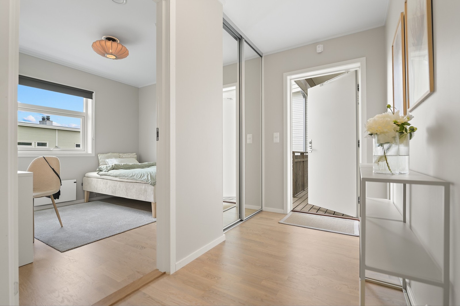 Lys og romslig inngangsparti med skyvedørsgarderobe. Galleribilde