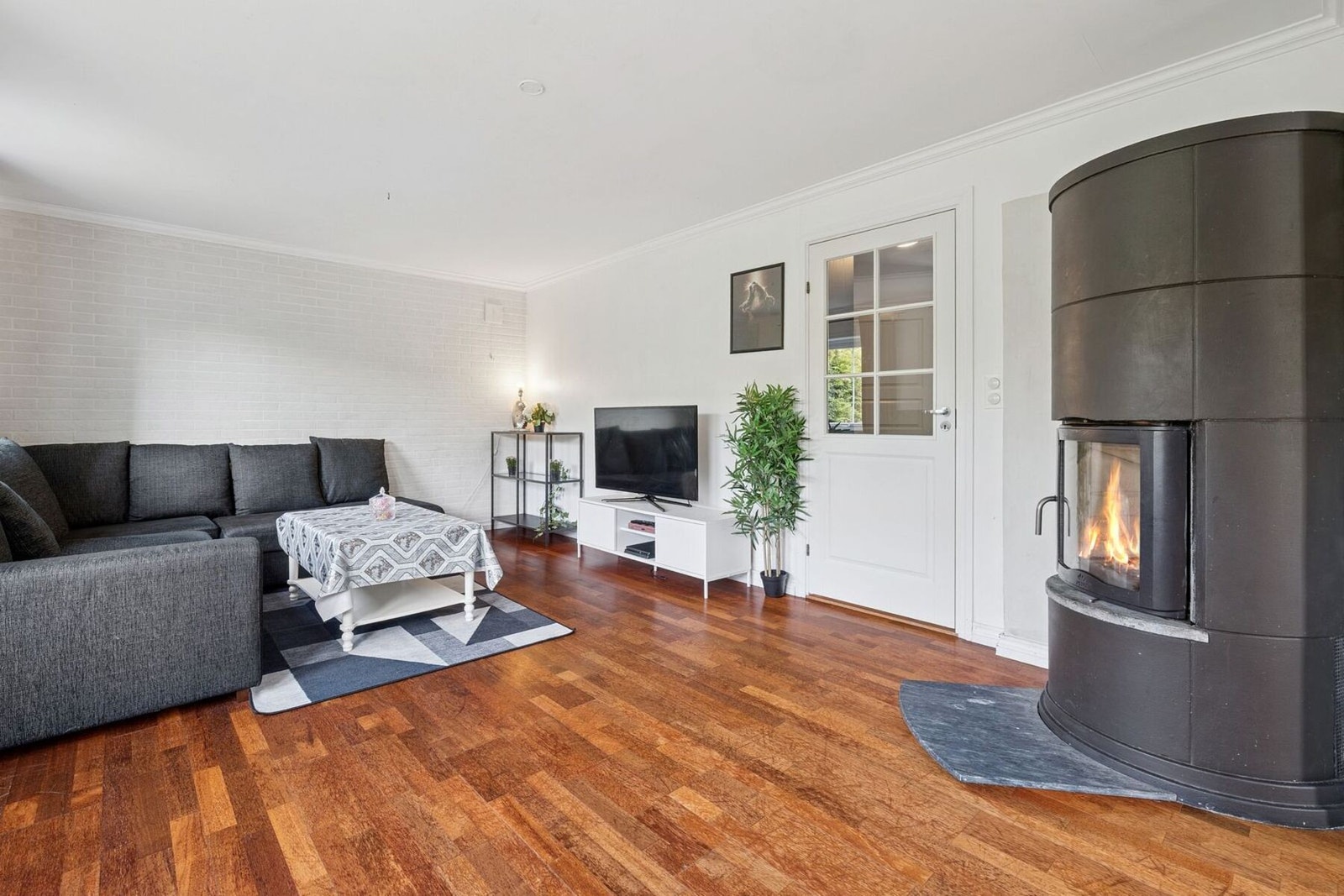 Videre er det også plass til større sofagruppe med tilhørende møblement. Stuen har en hyggelig peisovn for god temperaturregulering på kaldere dager. Galleribilde