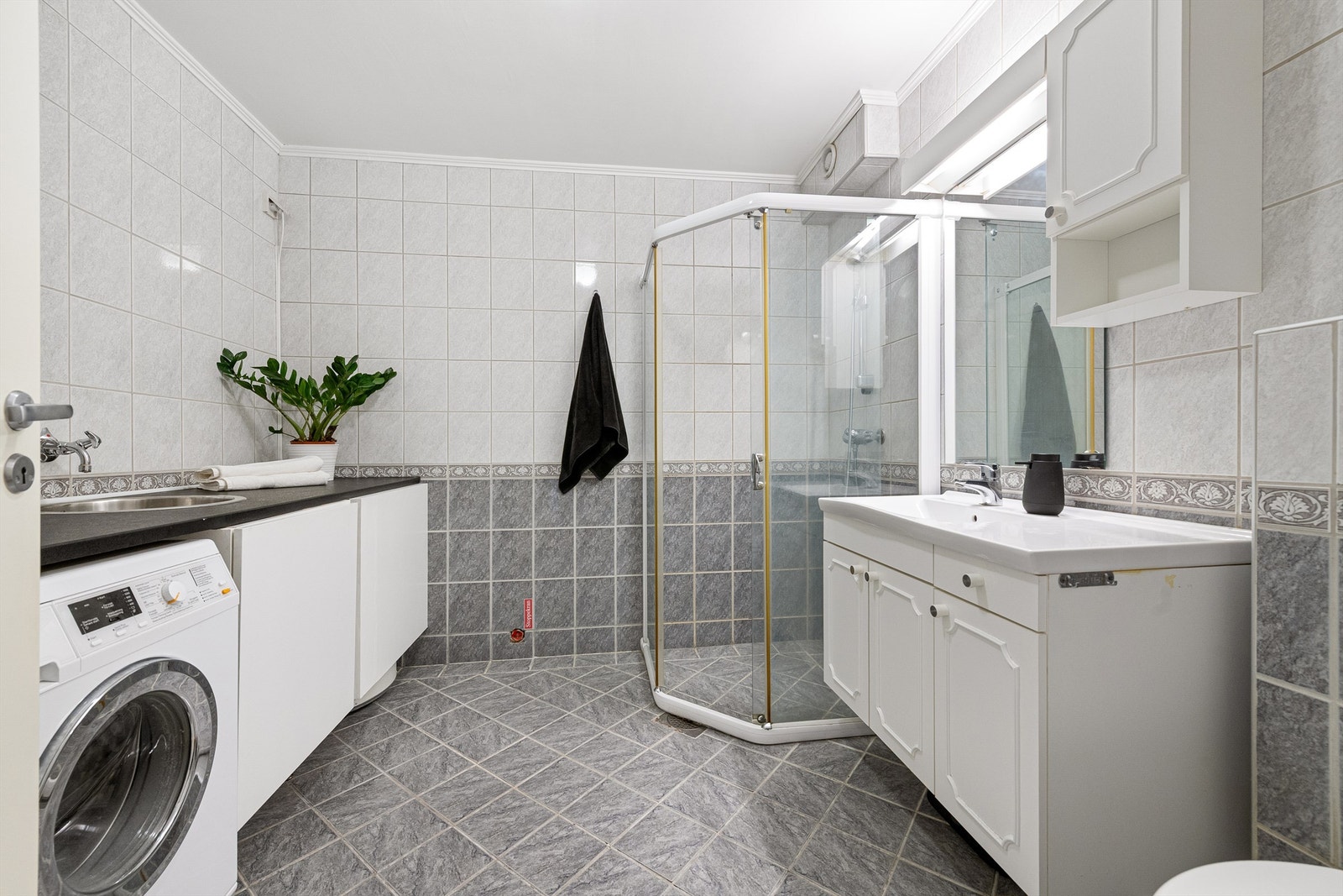 Romslig bad med innredning, speil, dusjhjørne og wc. Galleribilde