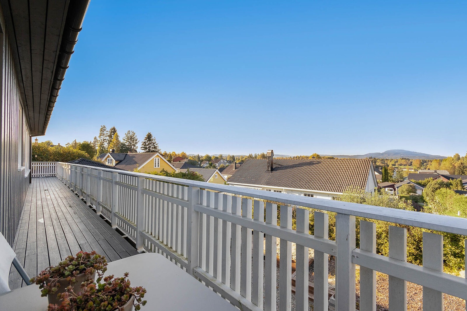 Romslig balkong med flott utsikt over nærområdet og åsene i det fjerne. Galleribilde