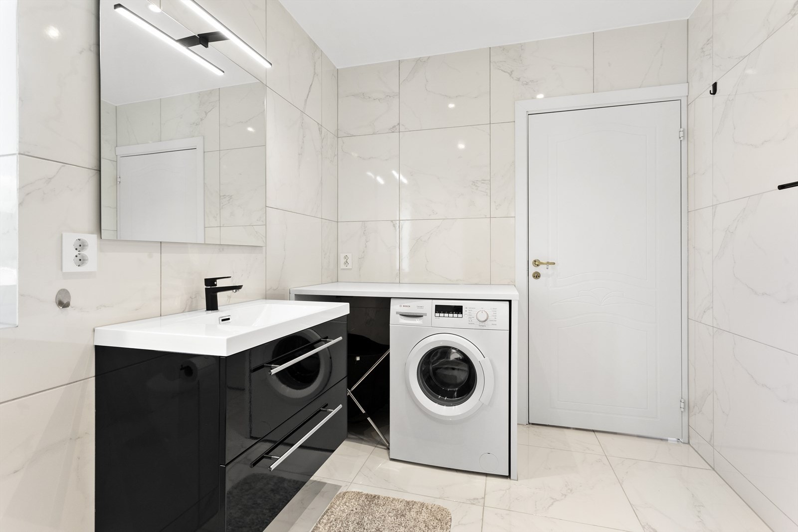 Innredningen består av et underskap, servant, speil, lys, stikk på vegg og en dusjsone med dusjing direkte på gulv og vegg. Galleribilde