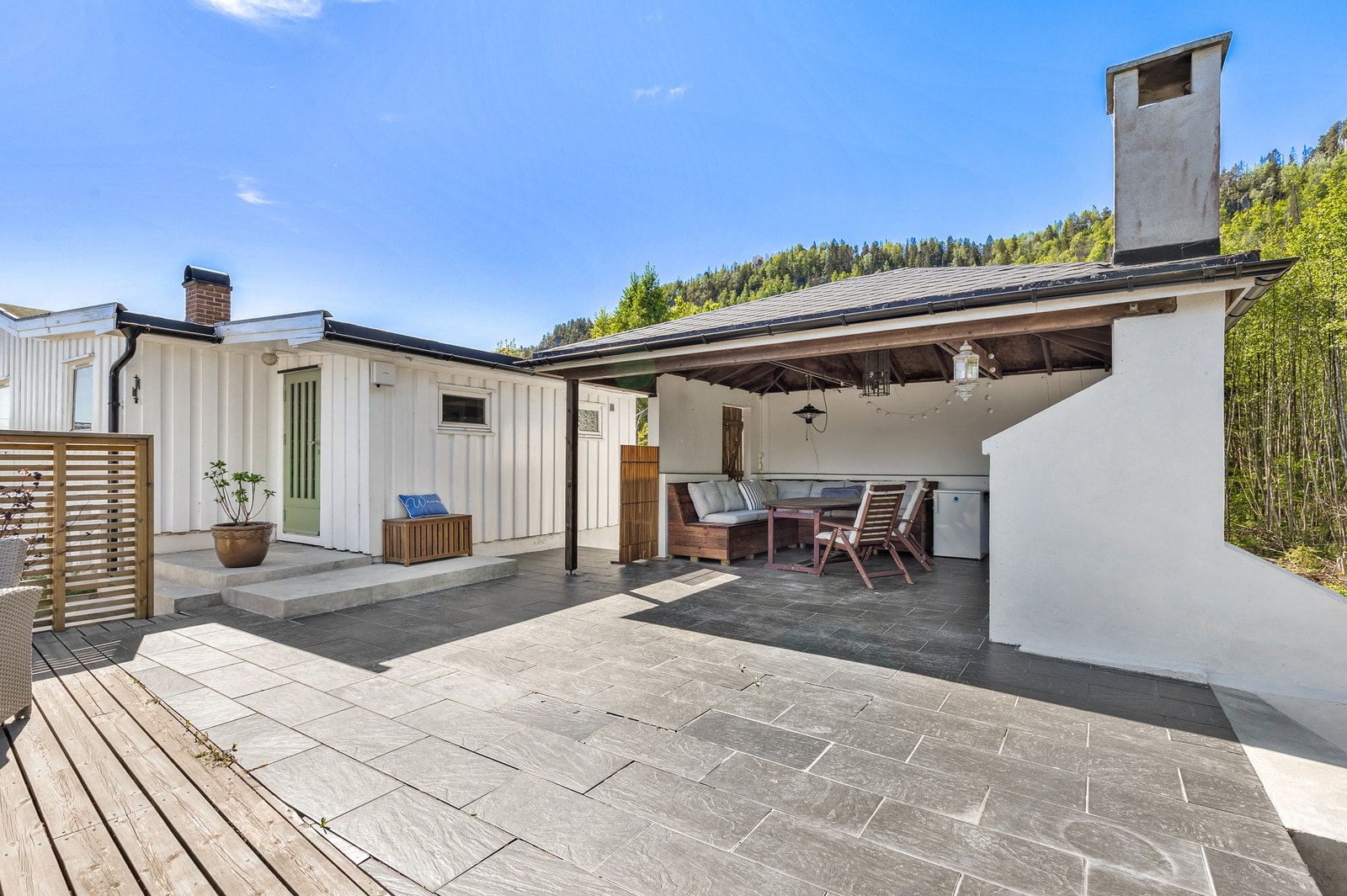 Eiendommen byr på flere nydelige uteplasser, herunder en stor utestue med peis Galleribilde