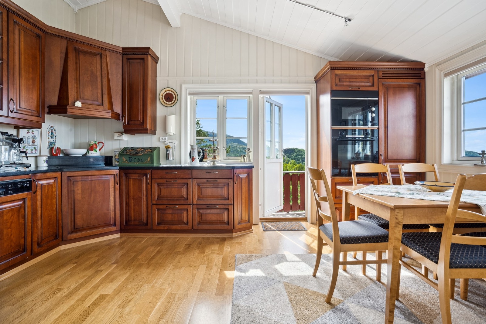 Kjøkkenet har integrerte hvitevarer og er godt utbygget med skap, skuff- og benkeplass. Galleribilde