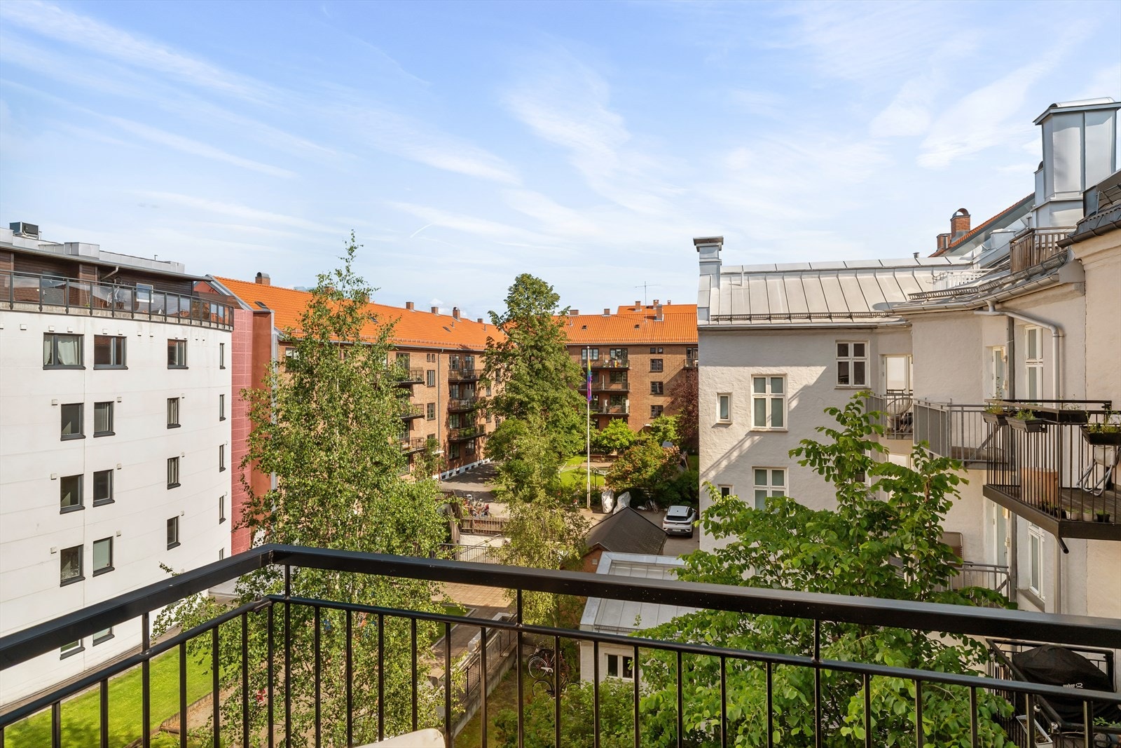 Grønt og frodig utsyn mot stille bakgård. Galleribilde