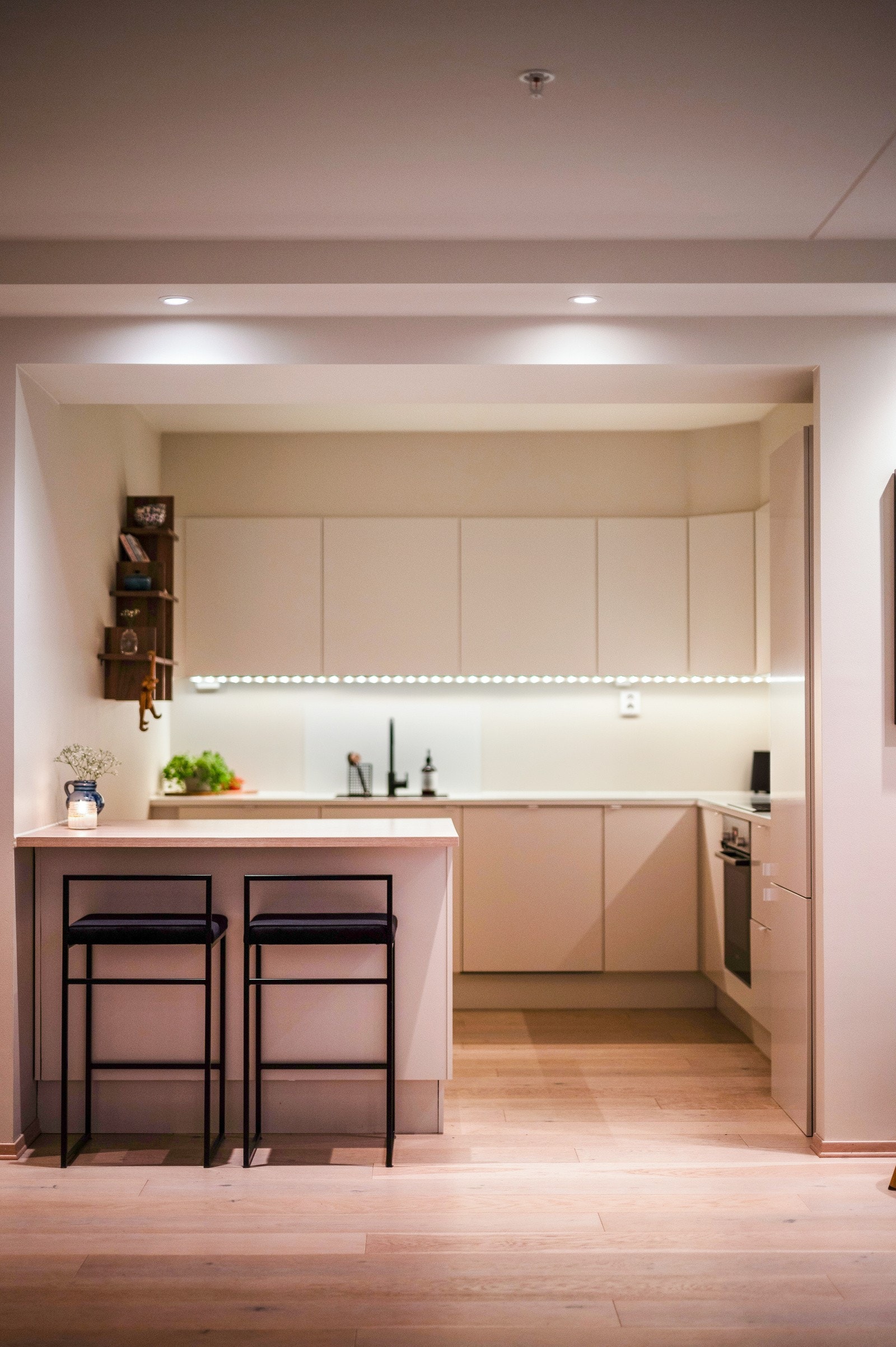 Det er integrerte hvitevarer, inkludert oppvaskmaskin, stekeovn, induksjonstopp og kjøl-/fryseskap, som gir en sømløs og praktisk løsning. Galleribilde