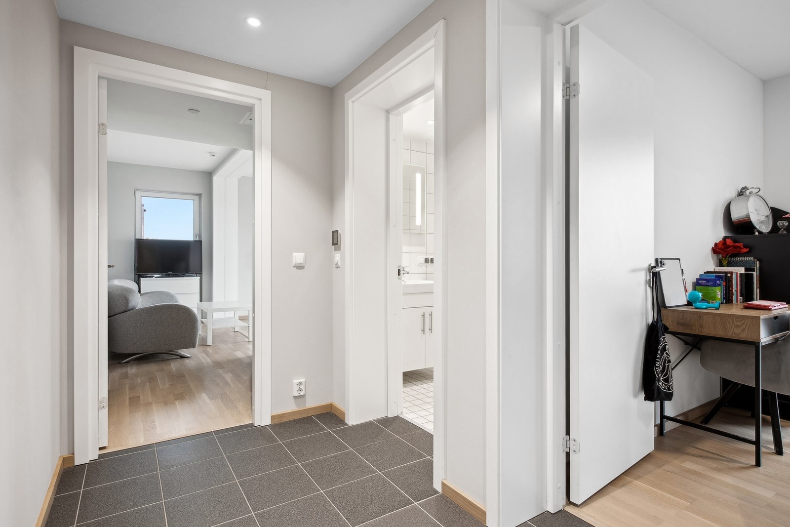 Den flislagte entreen tar deg videre inn i leiligheten med umiddelbar adkomst til soverom og baderom. Galleribilde