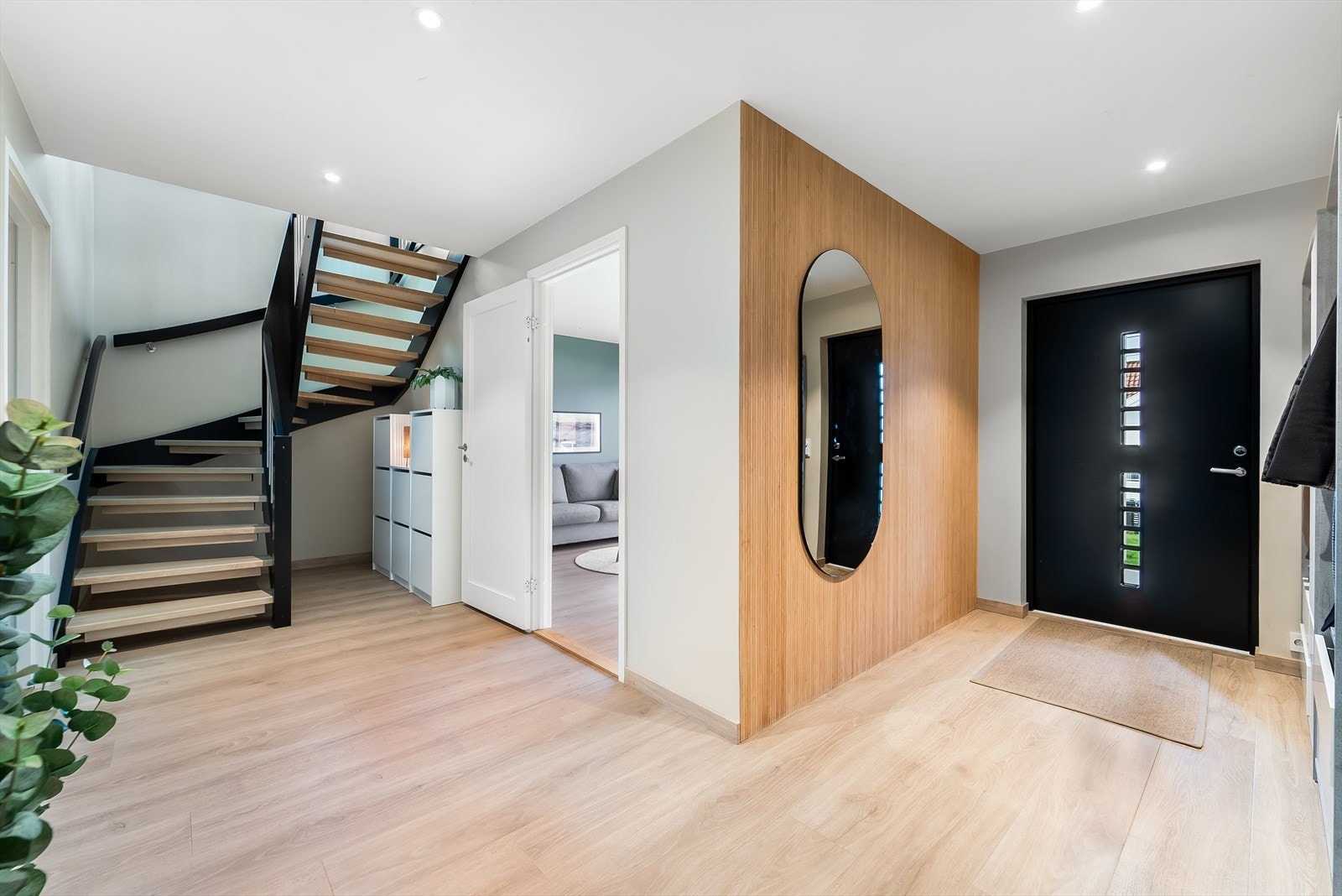 Entre med flott trapp drar de svarte detaljene i huset med seg opp i 2. etasje. Galleribilde