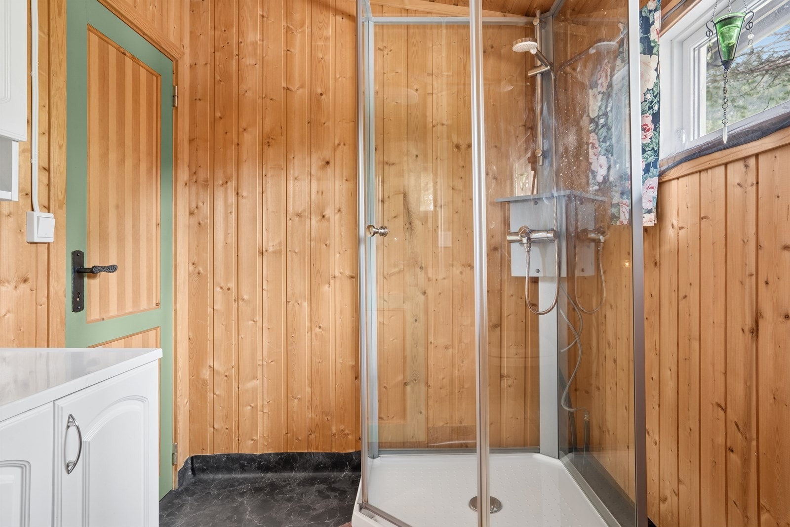 Baderom innredet med dusjkabinett og innredning med servant. Galleribilde