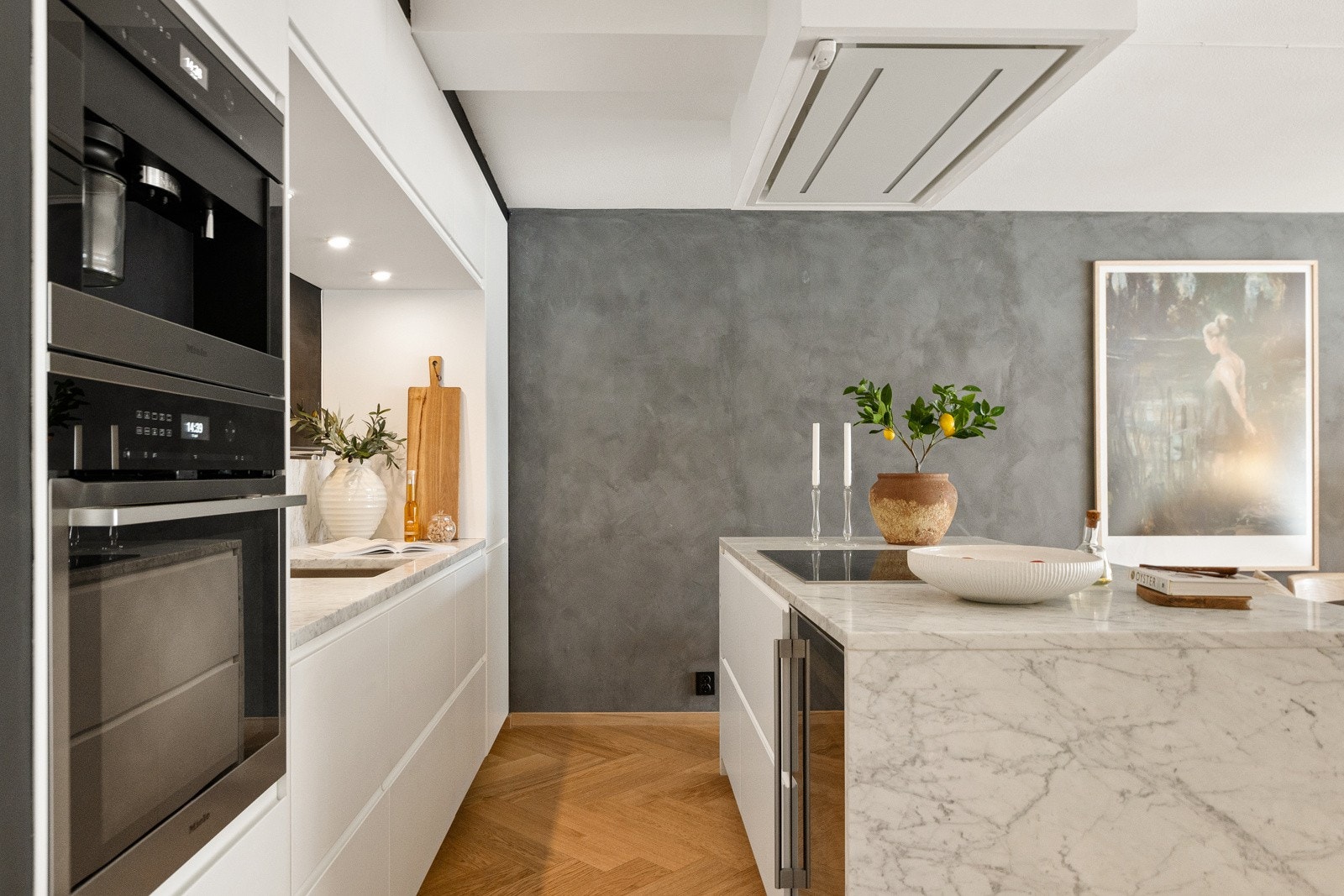 Videre er kjøkkenet utstyrt med en stilren veggplate i marmor over benkeplaten, som gir et elegant uttrykk. Galleribilde