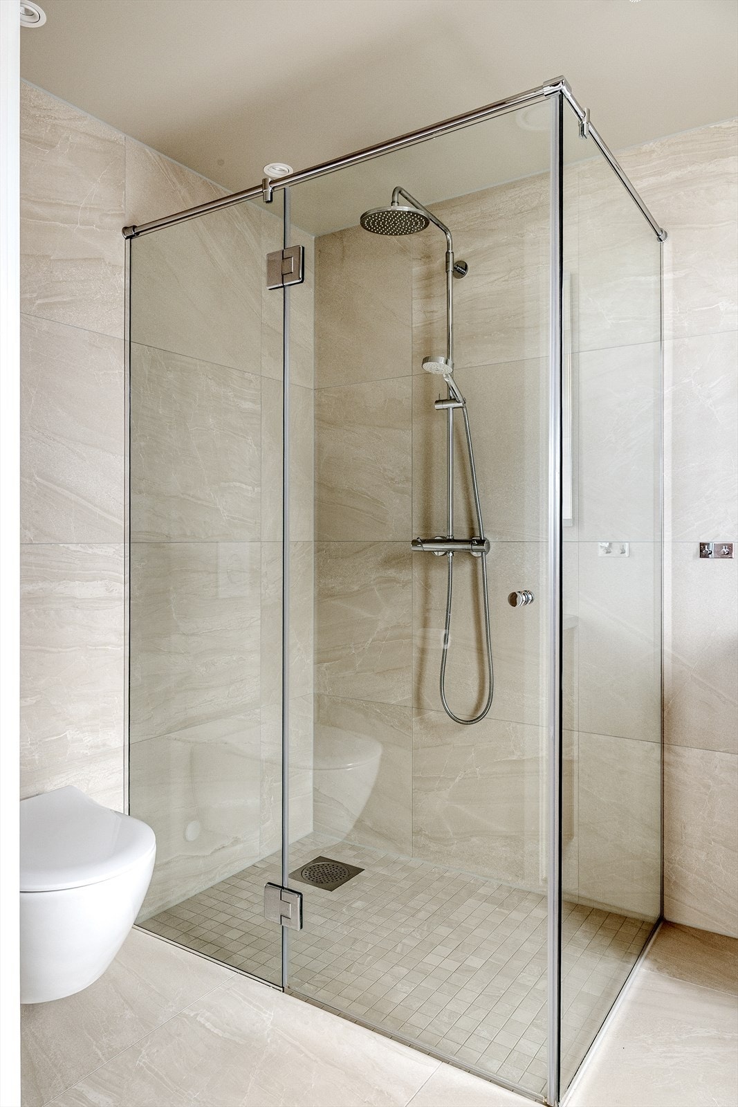 Badene er tidløse og moderne med fliser på vegger og gulv. Badene er innredet med vask i seksjon med skuffeplass, speil med belysning, dusjhjørne og vegghengt toalett. Begge badene har downlights i himling og vannbåren varme i gulv. Galleribilde