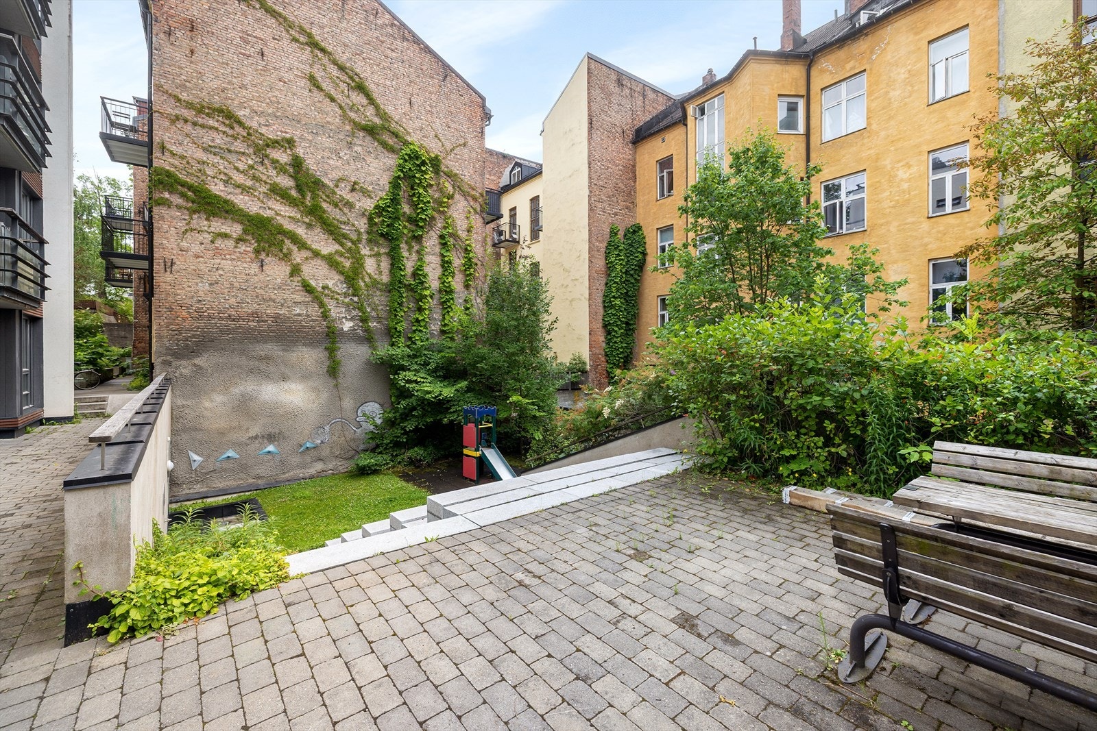 Det er flere sittegrupper og lekeapparater for beboerne. Galleribilde