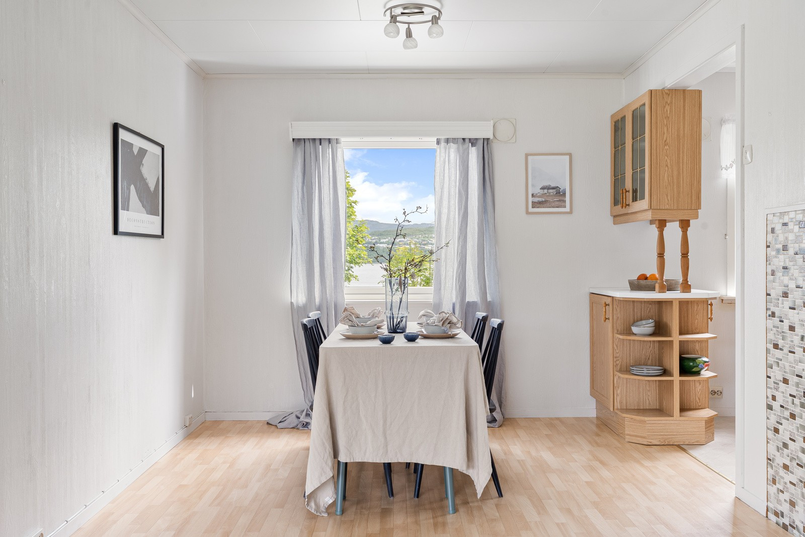 God plass til stort spisebord like ved kjøkkenet i tillegg til frokostbord på kjøkken.