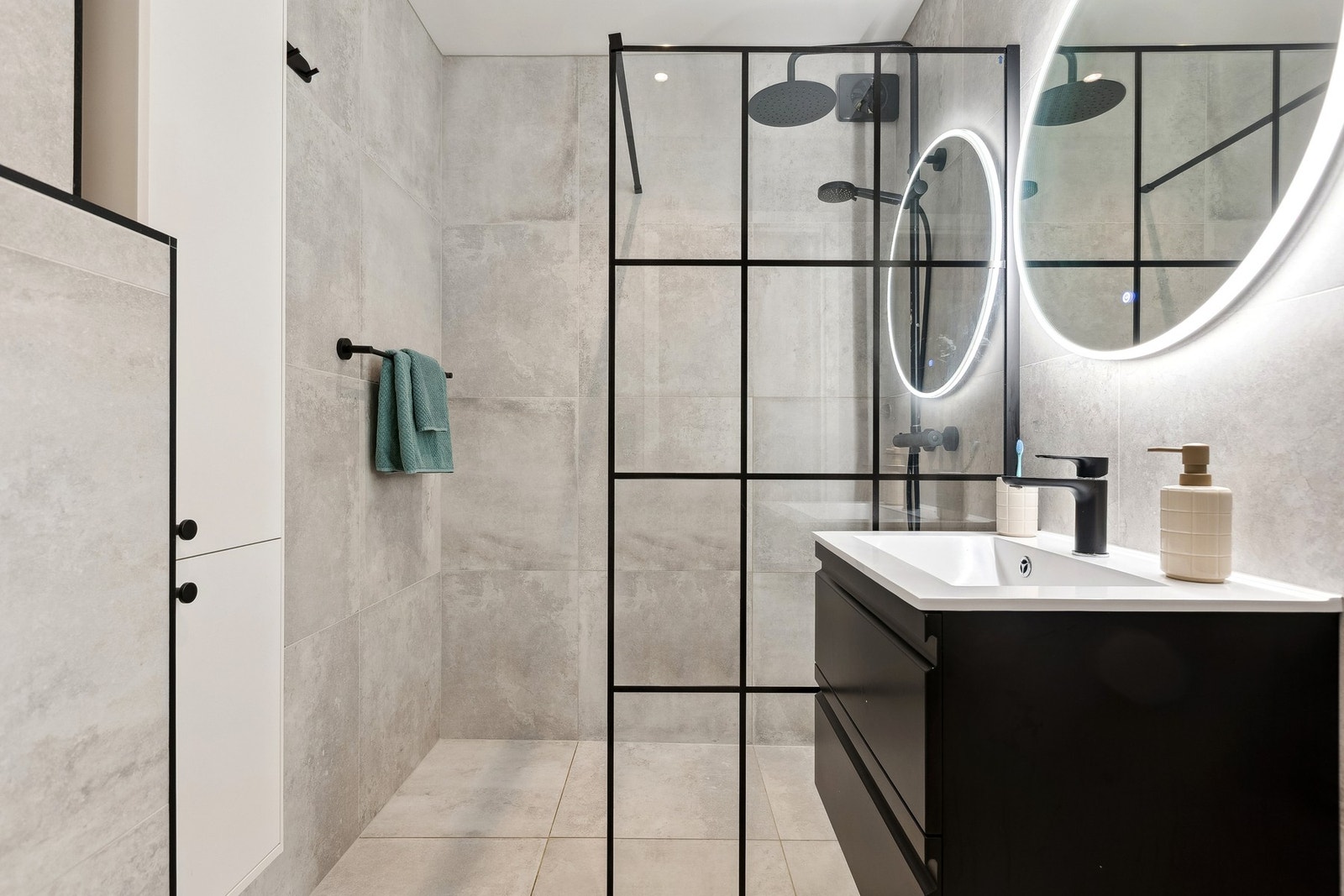 Delikat bad utstyrt med servantinnredning, speil med lys, dusjnisje med glassvegg og toalett. Galleribilde