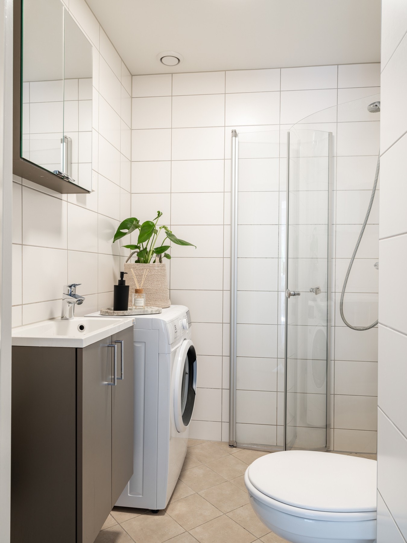 Leilighetens rolige og helhetlige preg fortsetter inn på badet, som er pent flislagt og utstyrt med det du trenger i hverdagen. Galleribilde