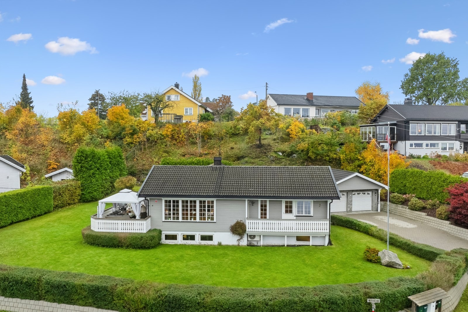 Eiendommen har en fin lettstelt hage med hekk Galleribilde