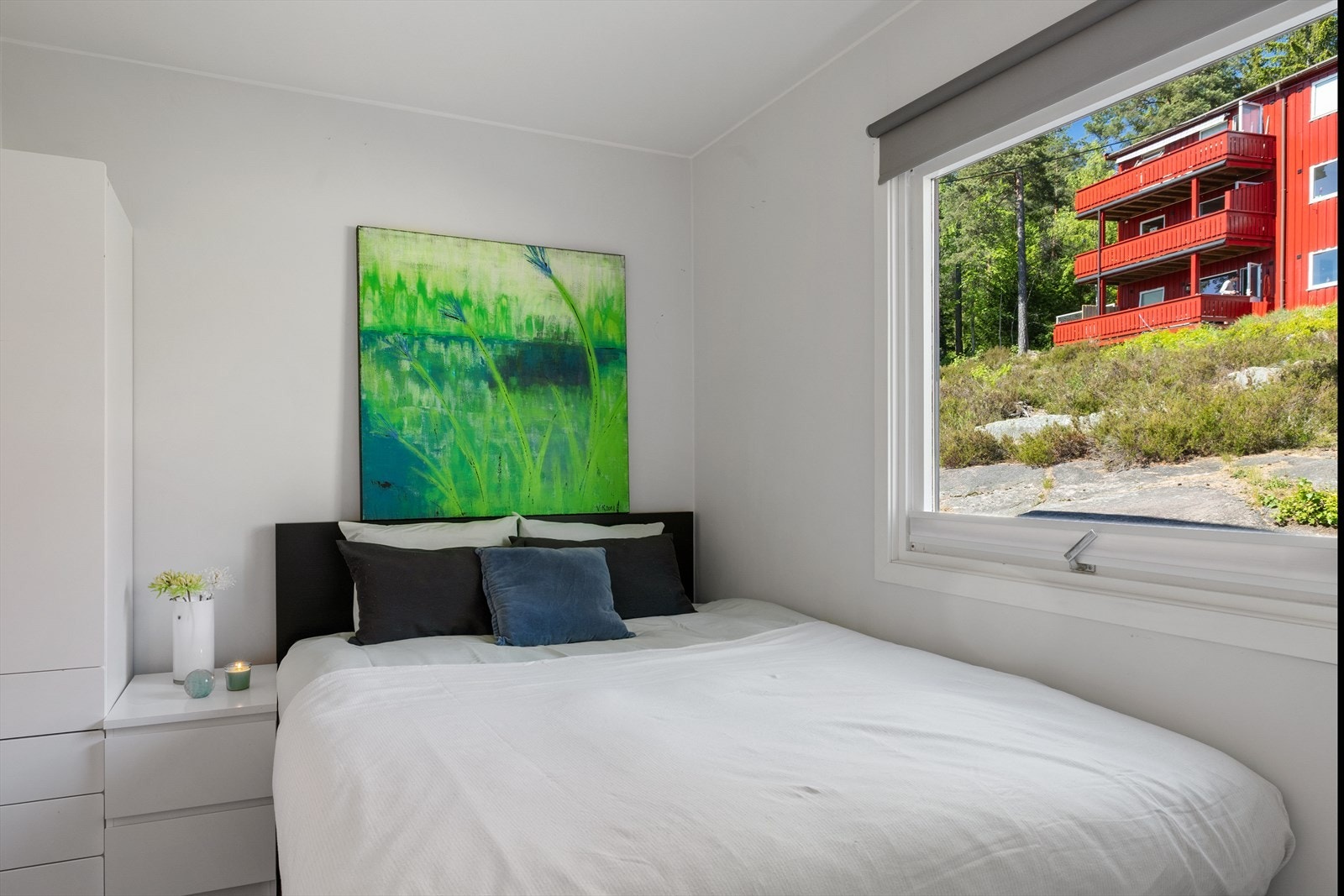 Boligen har to soverom med lyse veggflater. Her er det svalt om sommeren. Galleribilde