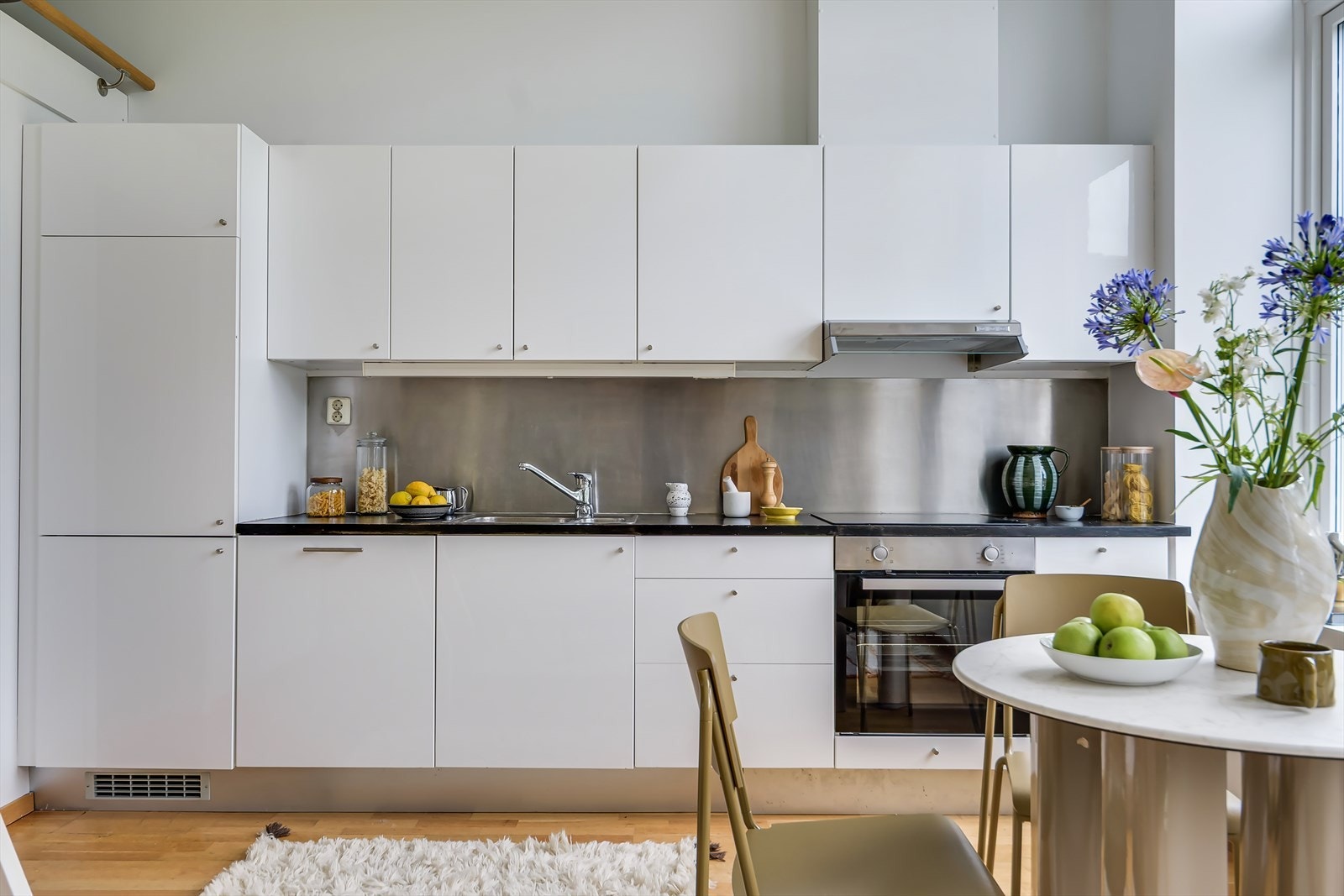 Kjøkkenet har integrerte hvitevarer, inkludert oppvaskmaskin, kombinert kjøl- og fryseskap, stekeovn og platetopp Galleribilde