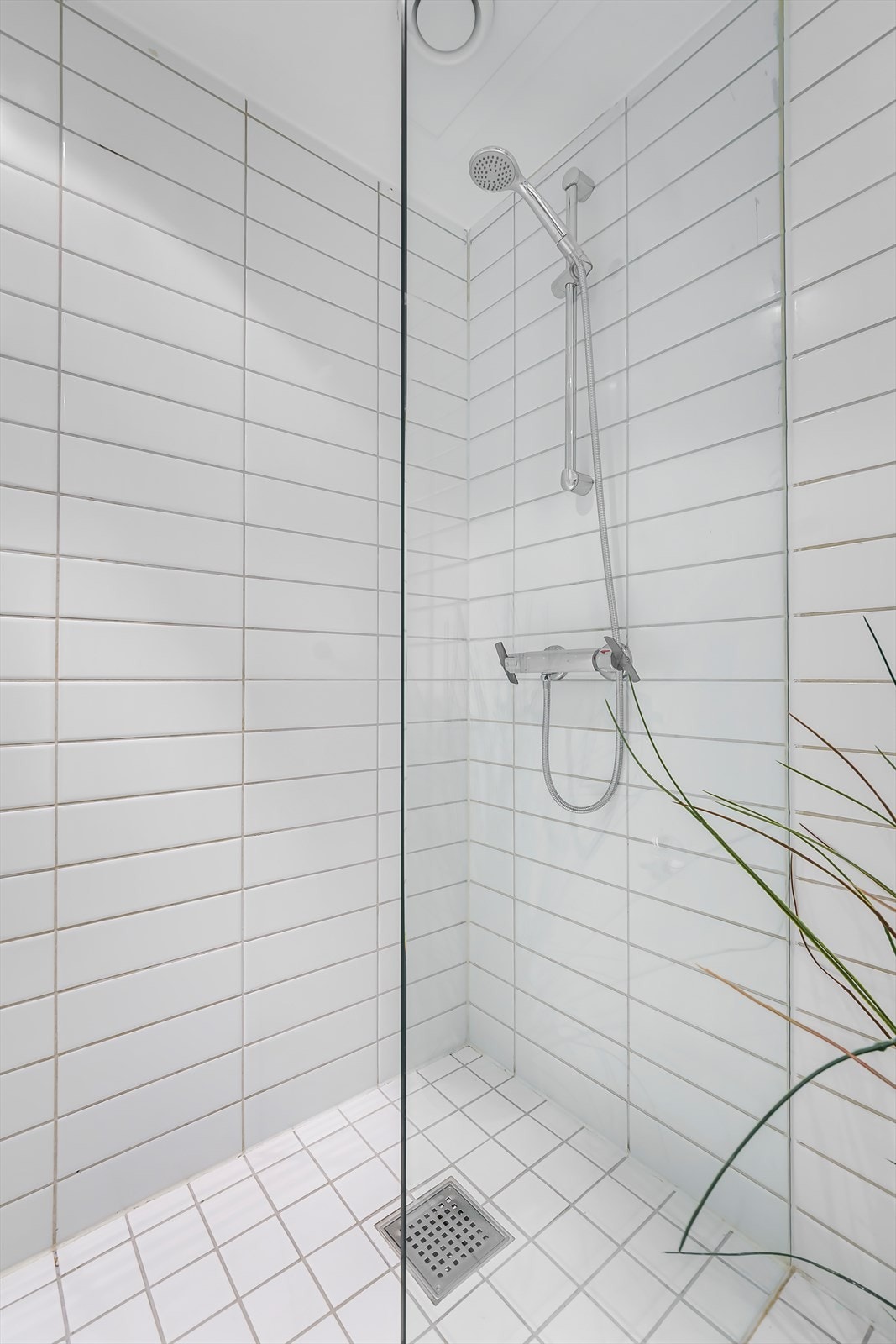 Innredningen består av servantskap, speil og dusjsone med dusjing direkte på gulv og vegg, avskjermet med svingbar glassvegg Galleribilde