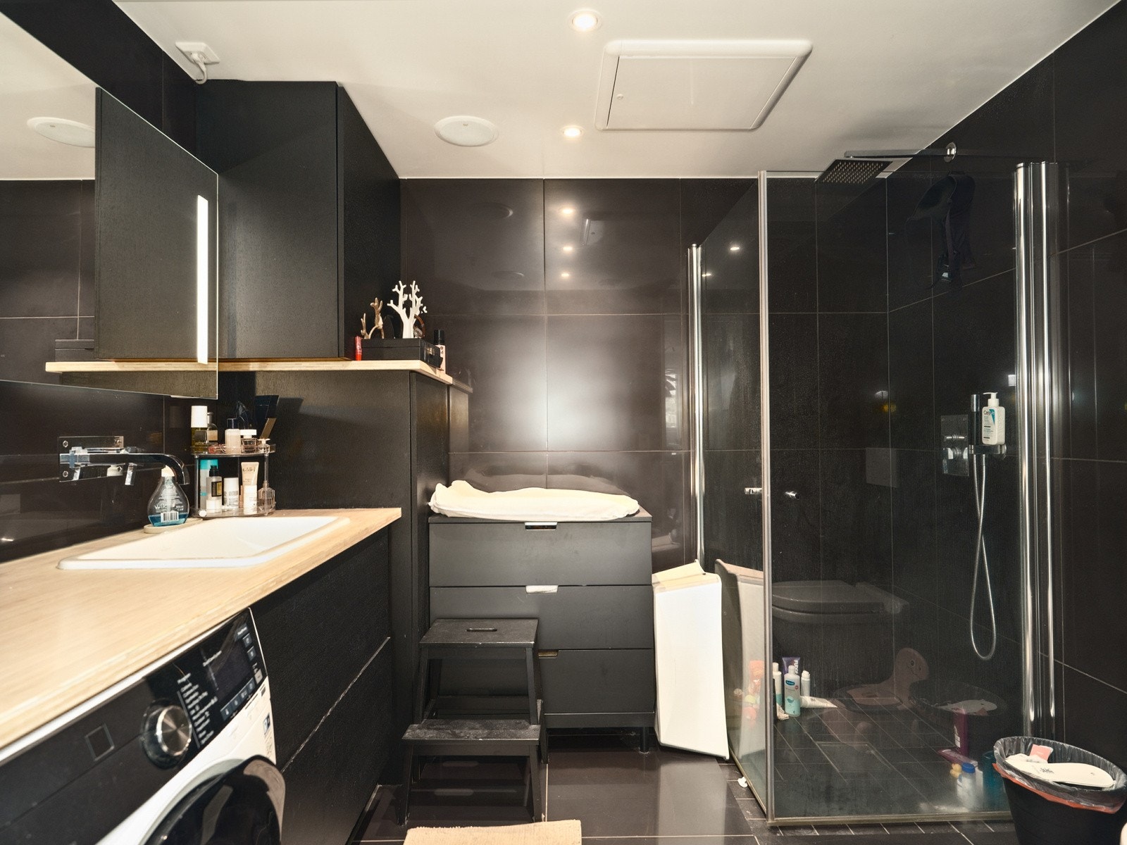 Badet fremstår som svært stilrent og moderne, med mørke fliser på vegger og gulv. Galleribilde