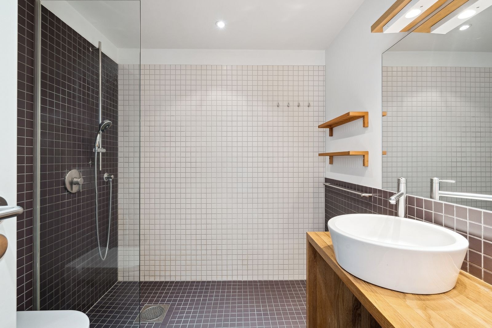 Flislagt baderom med vegghengt toalett. Vaskemaskin og tørketrommel medfølger. Galleribilde