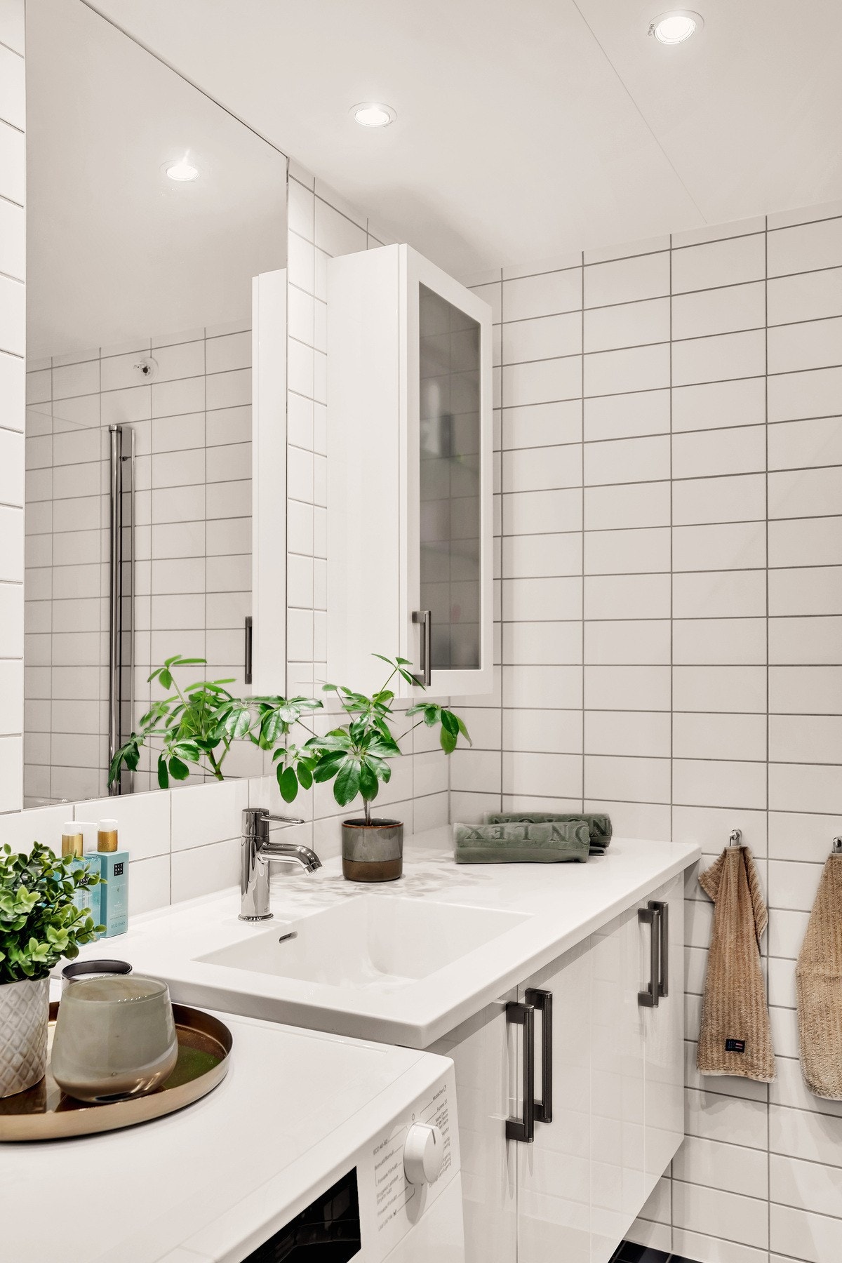 Badet er innredet med vegghengt servantskap, speil med belysning samt ekstra oppbevaringsskap på vegg. Galleribilde