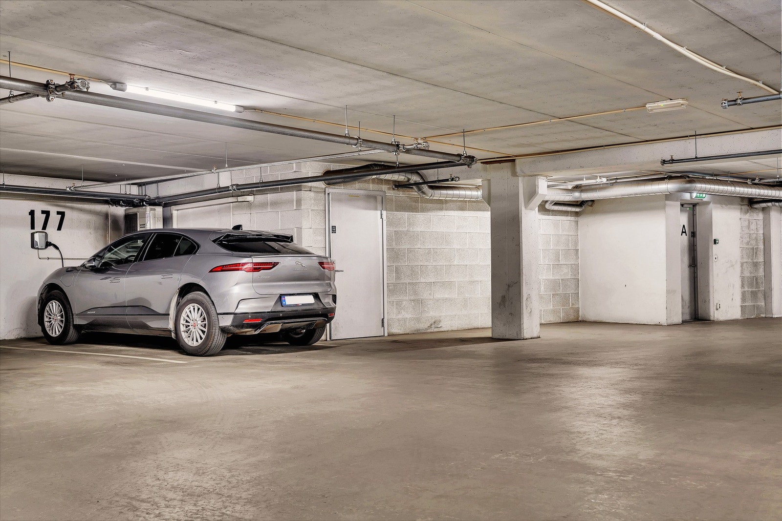 Leiligheten disponerer en biloppstillingsplass med elbil-lader i felles garasjeanlegg i underetasje med direkte adgang via heis. Galleribilde