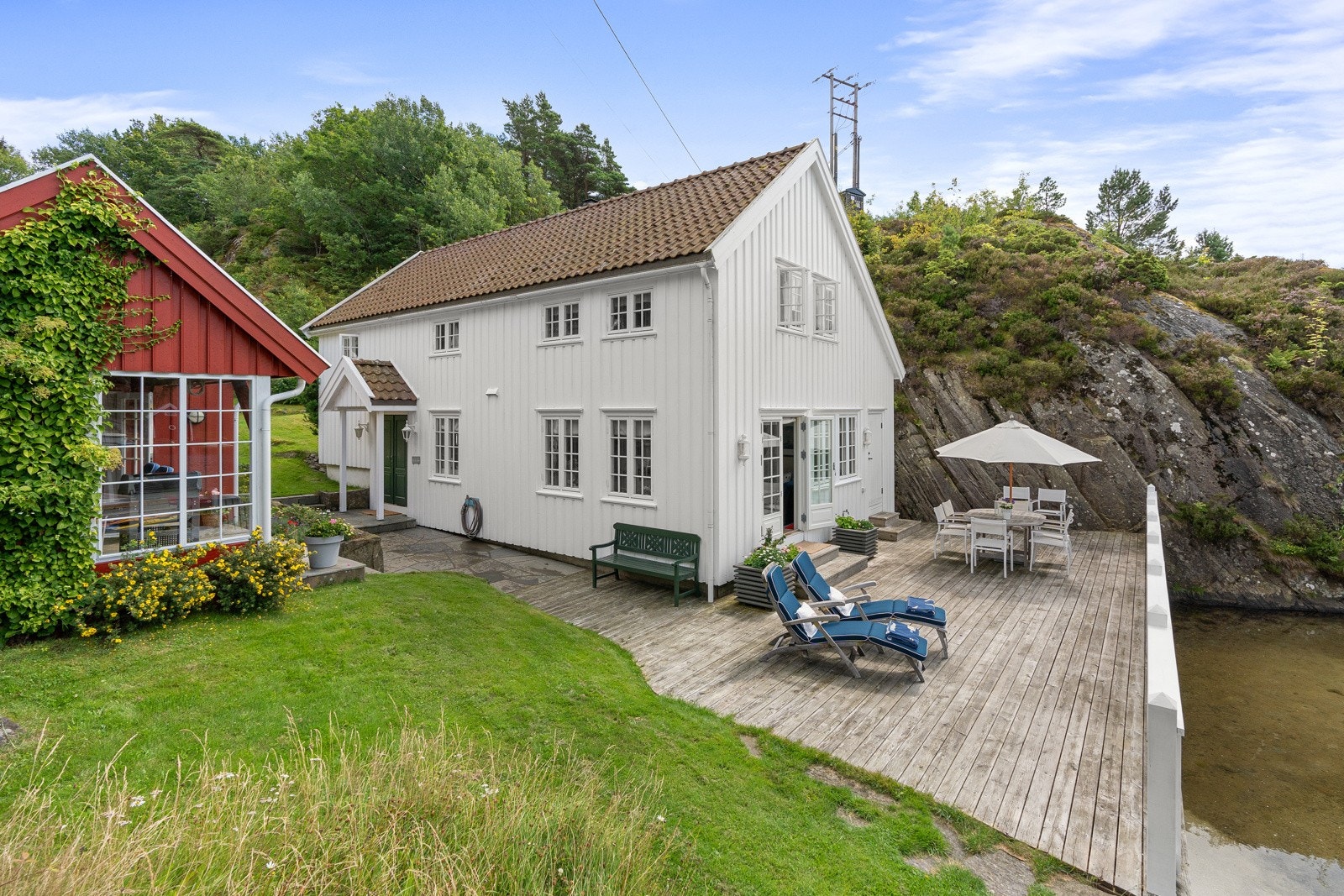 Hytten med terrasse utenfor - og del av anneks på siden Galleribilde