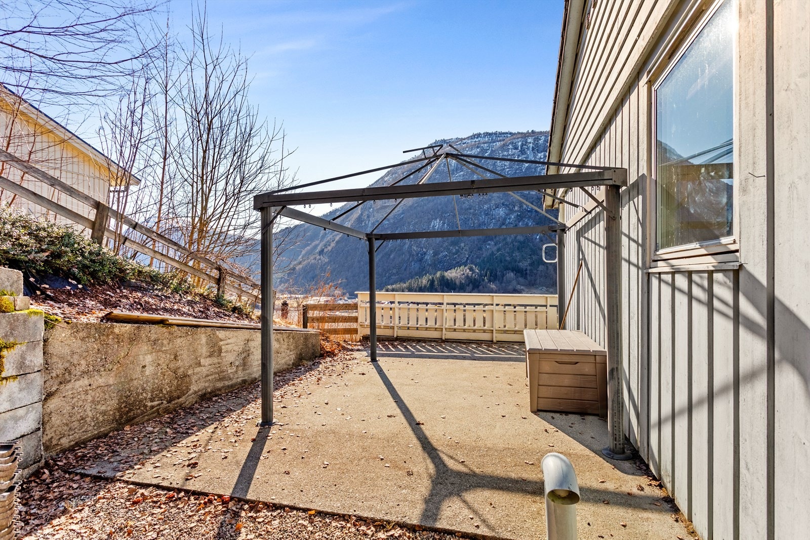 Uteområde med dekke av betong og ettermiddagssol. Galleribilde