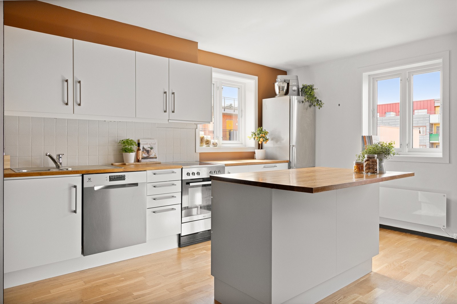 Stilrent kjøkken fra HTH, blant annet oppgradert i 2014. Kjøkkeninnredning med glatte fronter i lys utførelse, heltre benkeplate med nedfelt oppvaskkum og ett-greps blandebatteri fra Oras Galleribilde