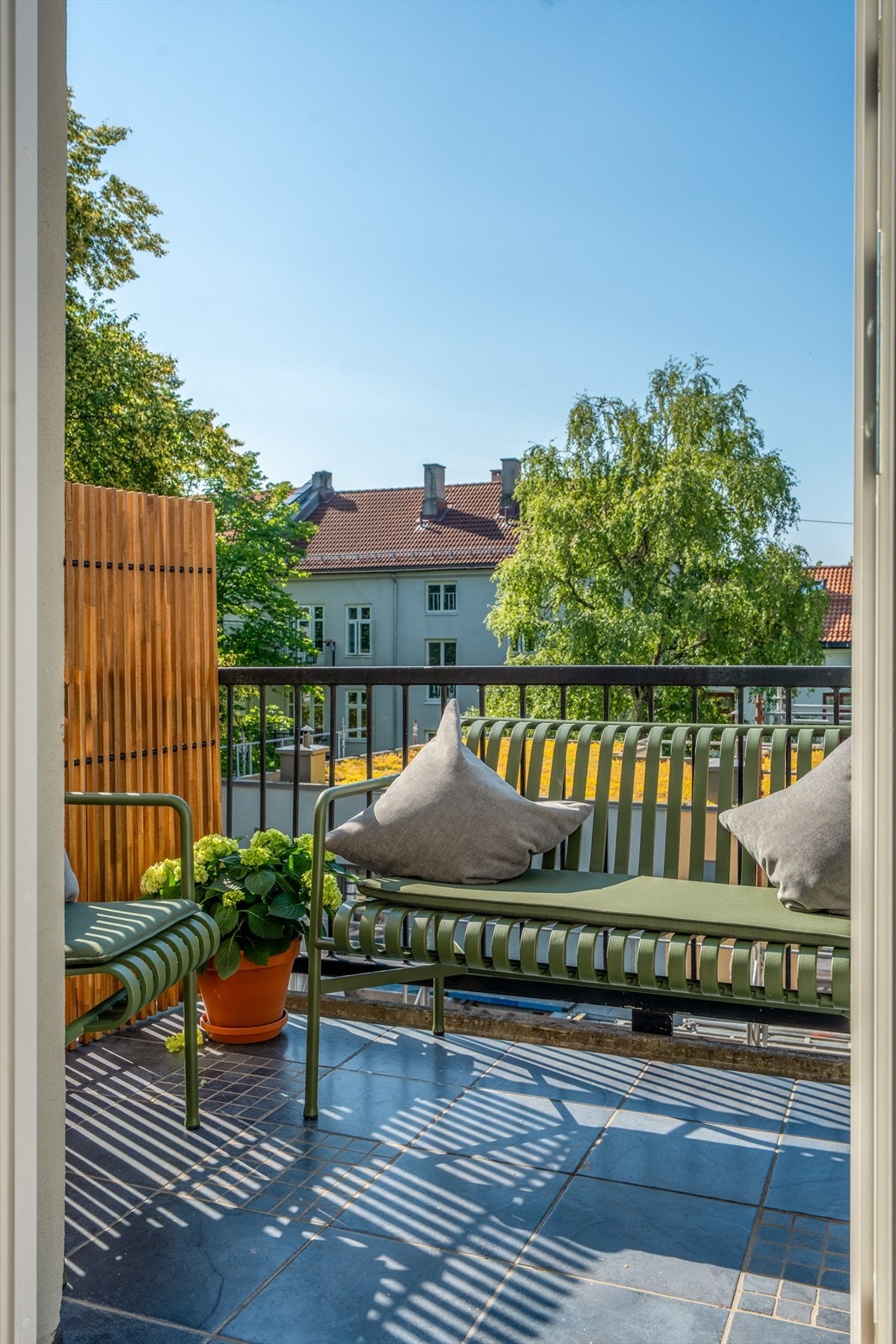 Balkongen er flislagt og har en frodig utsikt. Her er det god plass til en sittegruppe og beplantning. Galleribilde